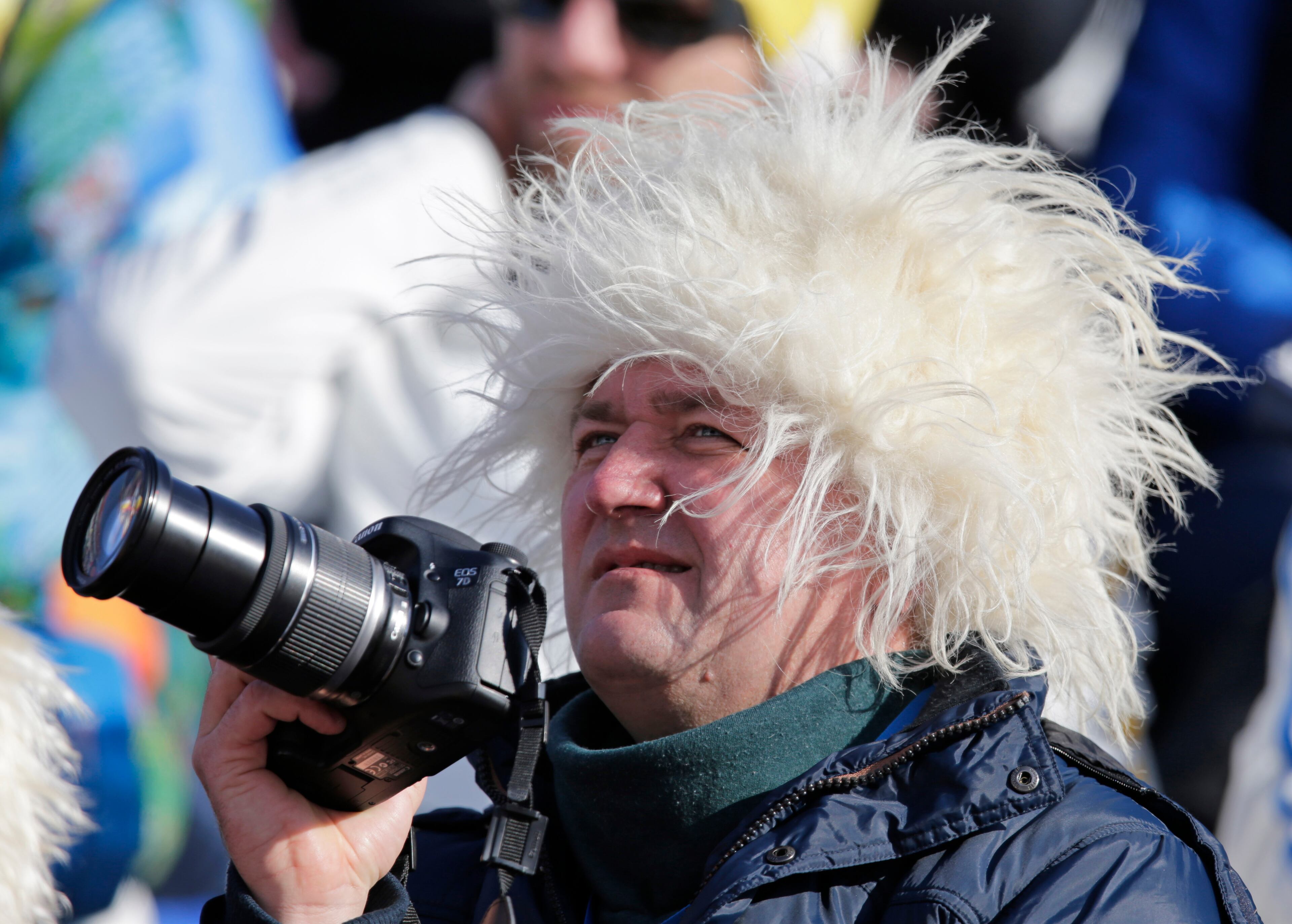 A spectator wears a fuzzy hat as he watches athletes compete in the downhill portion of the women's supercombined at the Sochi 2014 Winter Olympics, Monday, Feb. 10, 2014, in Krasnaya Polyana, Russia. (AP Photo/Gero Breloer)