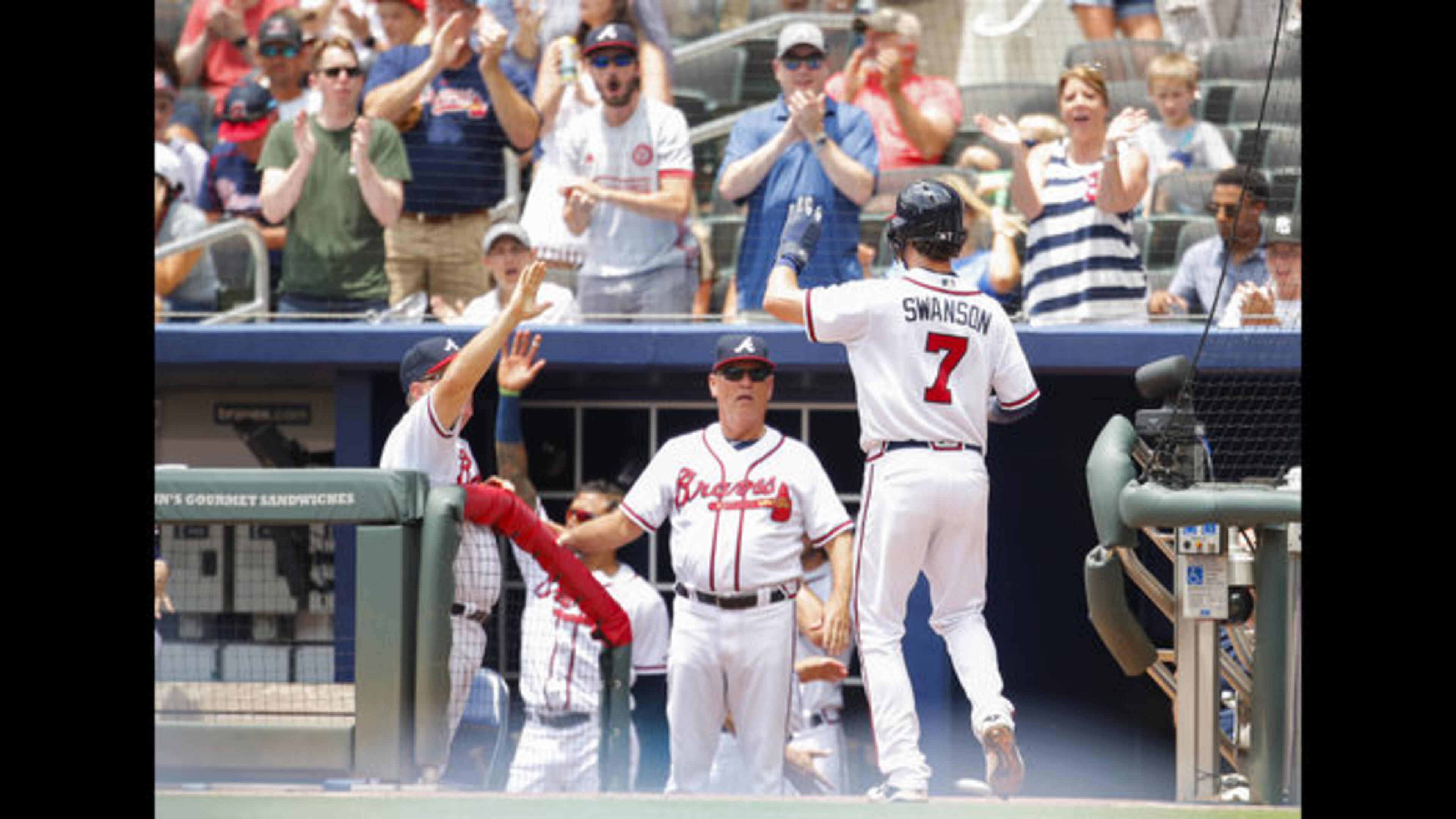 Atlanta Braves shortstop Dansby Swanson is congratulated after scoring during a recent game.