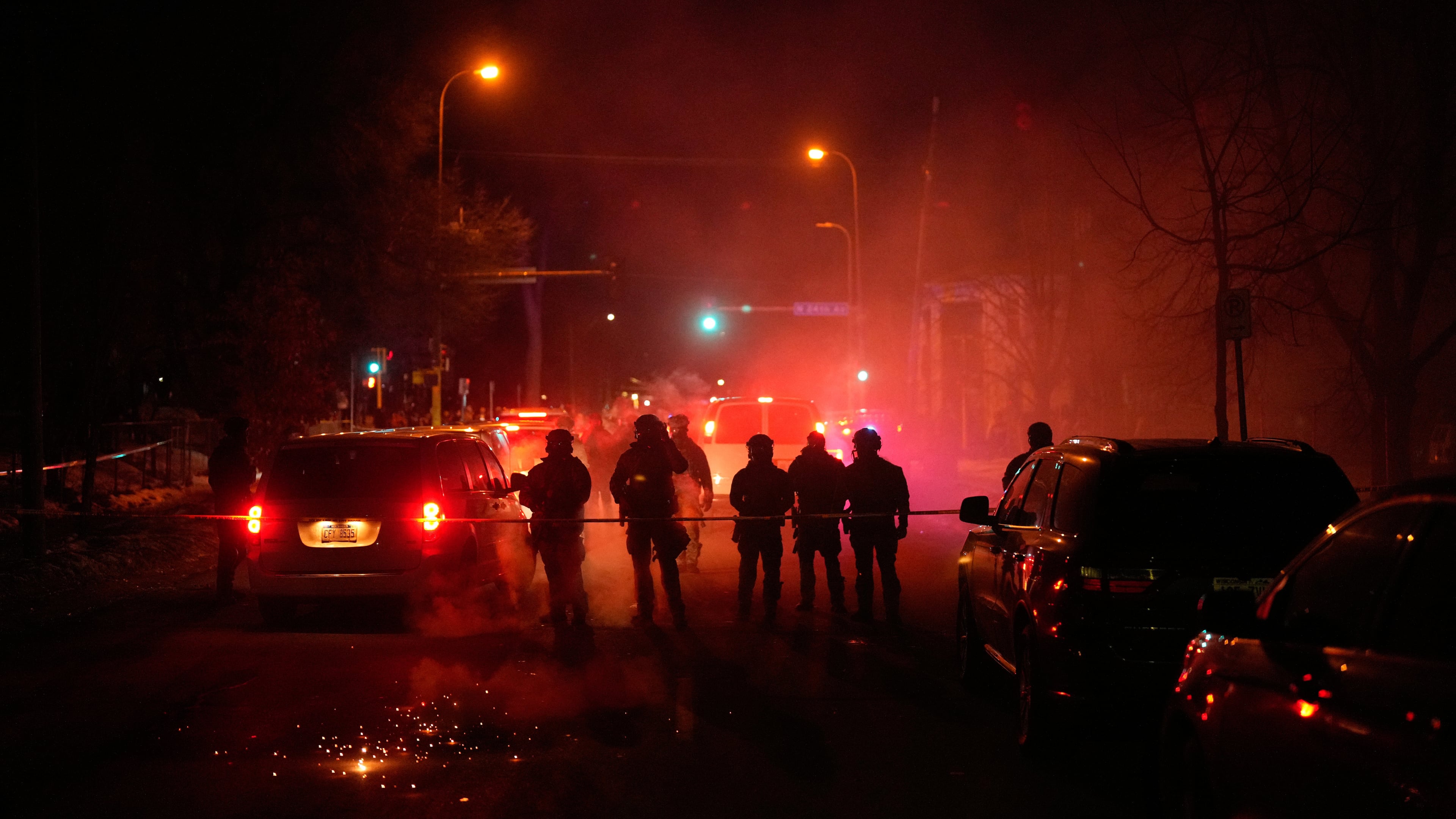 FILE - Tear gas surrounds federal law enforcement officers as they leave a scene after a shooting on Jan. 14, 2026, in Minneapolis. (AP Photo/John Locher, File)