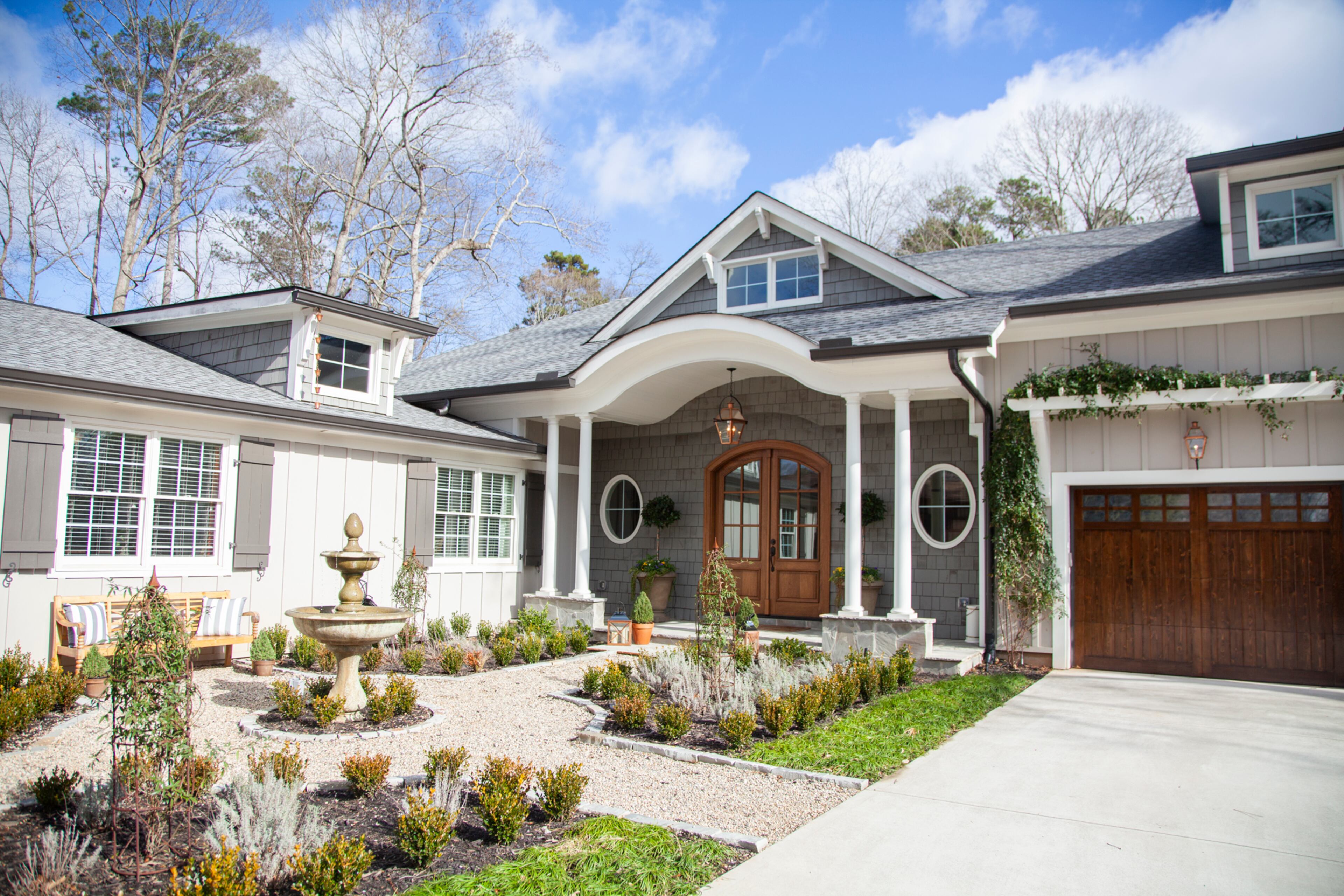 The home in Marietta's Indian Hills Country Club has 4,500 square feet, six bedrooms, five-and-a-half baths. Built in 1972, it was renovated in 2015, and the 8-foot mahogany front door with glass panes is where the original garage was located. Favorite features are the parterre courtyard with a fountain, eyebrow front porch with double columns and oval Craftsman windows.