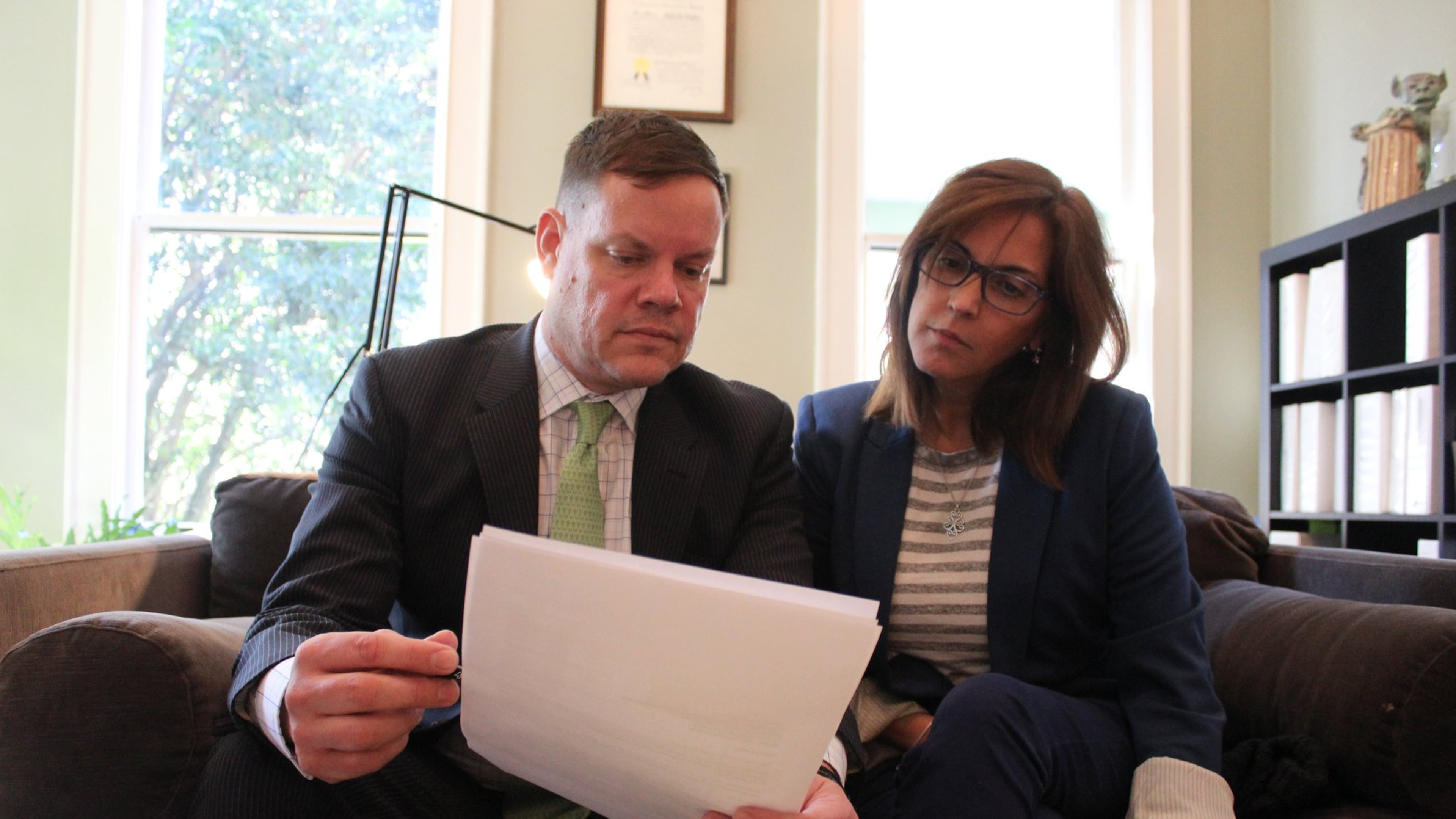 Nilsa Algarin Nieves and her attorney, Craig Kuglar, look over documents involving a hedge fund under scrutiny from federal authorities. Nieves and her husband, Edgard Nieves, have filed a lawsuit against the fund and its managers, saying investors had suffered millions of dollars in damages.