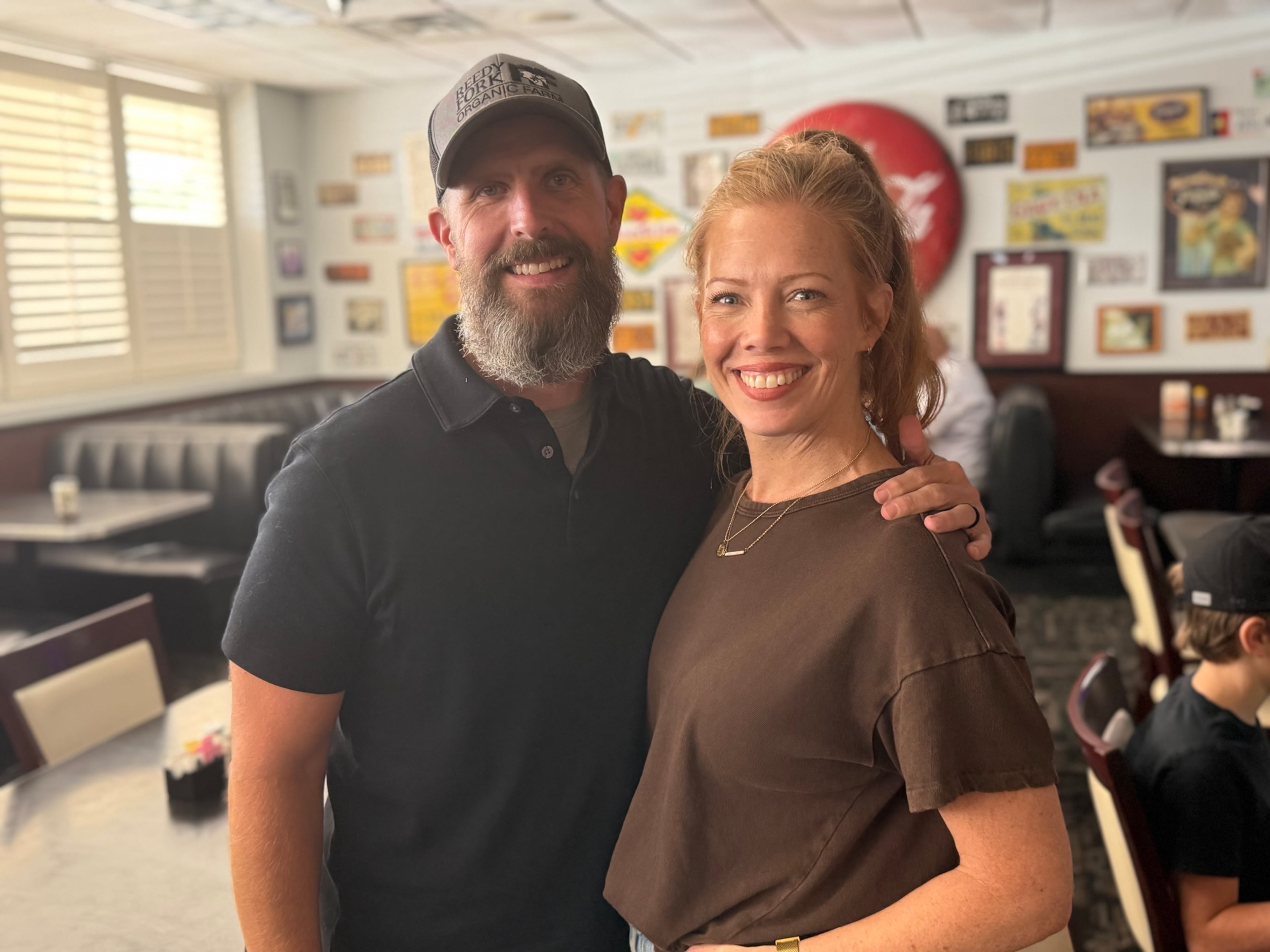 Justin and Heather Koch pose for a picture at the Dixie Diner in Texarkana, Texas. Since retiring from the U.S. Army, Justin Koch dedicated his time and resources to fighting the developments, including one project proposed by a firm linked to Republican Rick Jackson. (Greg Bluestein/AJC)