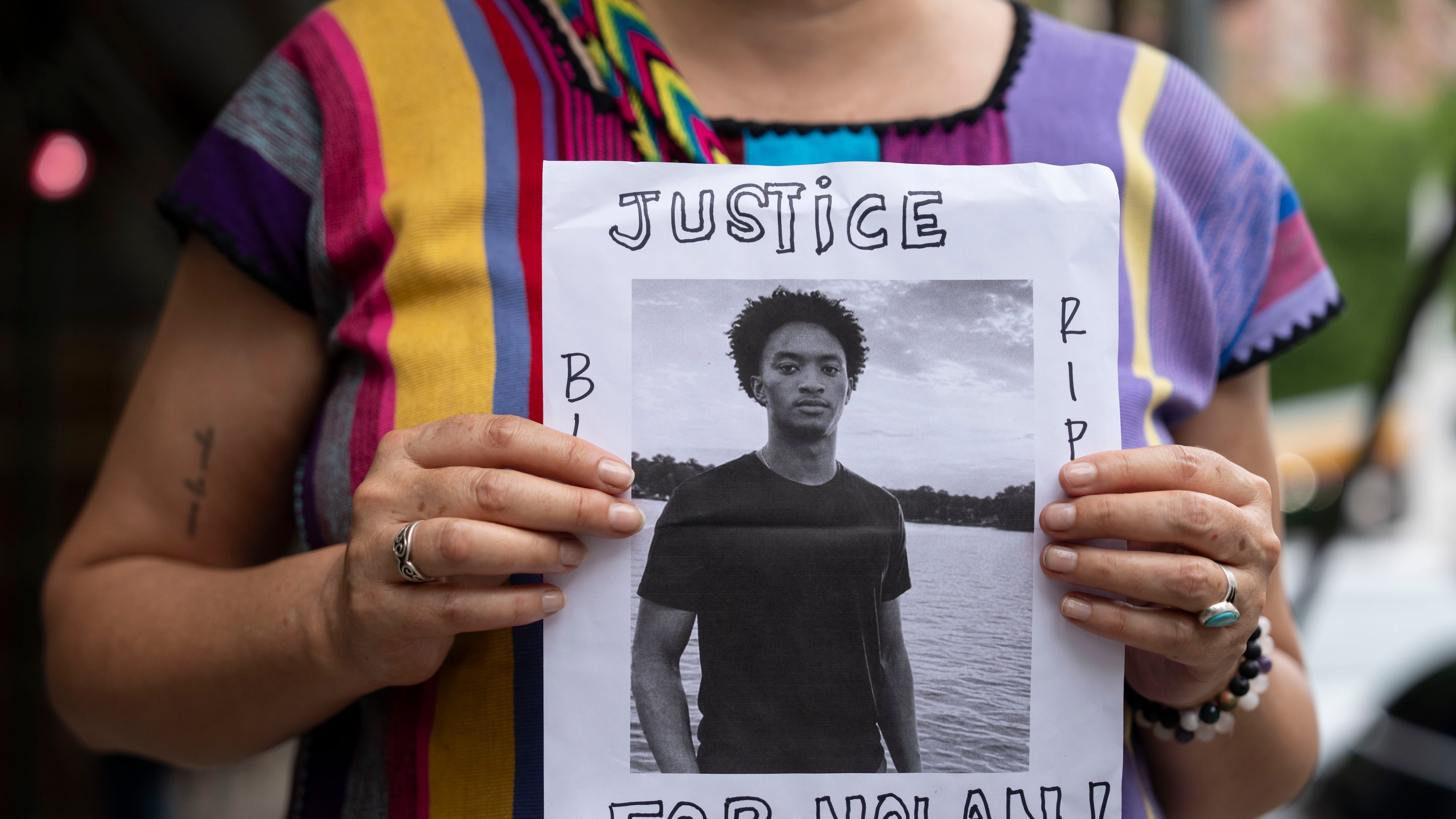 FILE - A person holds a picture of Nolan Xavier Wells during a news conference at National Action Network headquarters, Friday, July 10, 2026, in New York. (AP Photo/Yuki Iwamura, File)