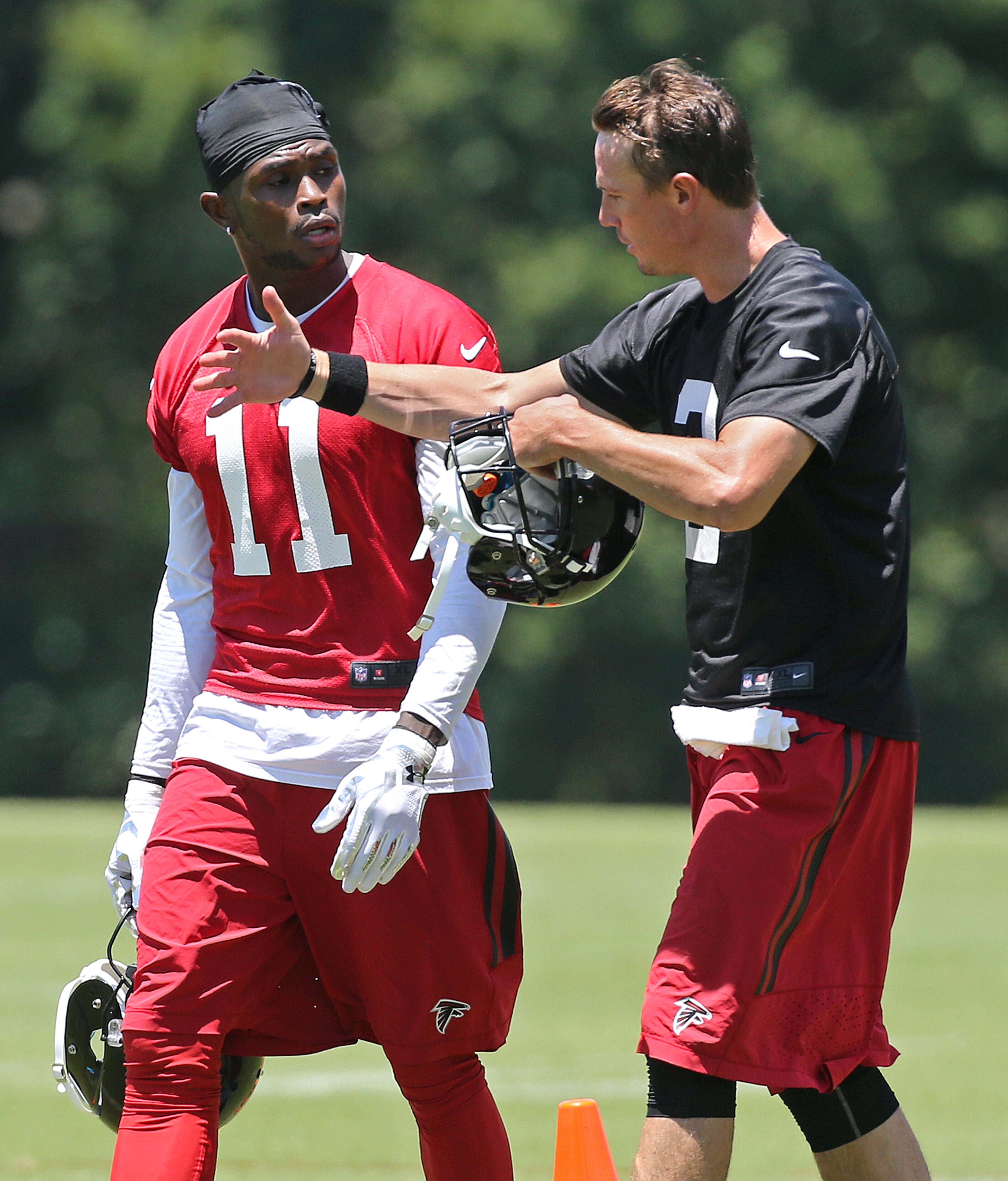 Falcons quarterback Matt Ryan and wide receiver Julio Jones confer during practice on an OTA day, Tuesday, June 7, 2016, in Flowery Branch. Curtis Compton / ccompton@ajc.com
