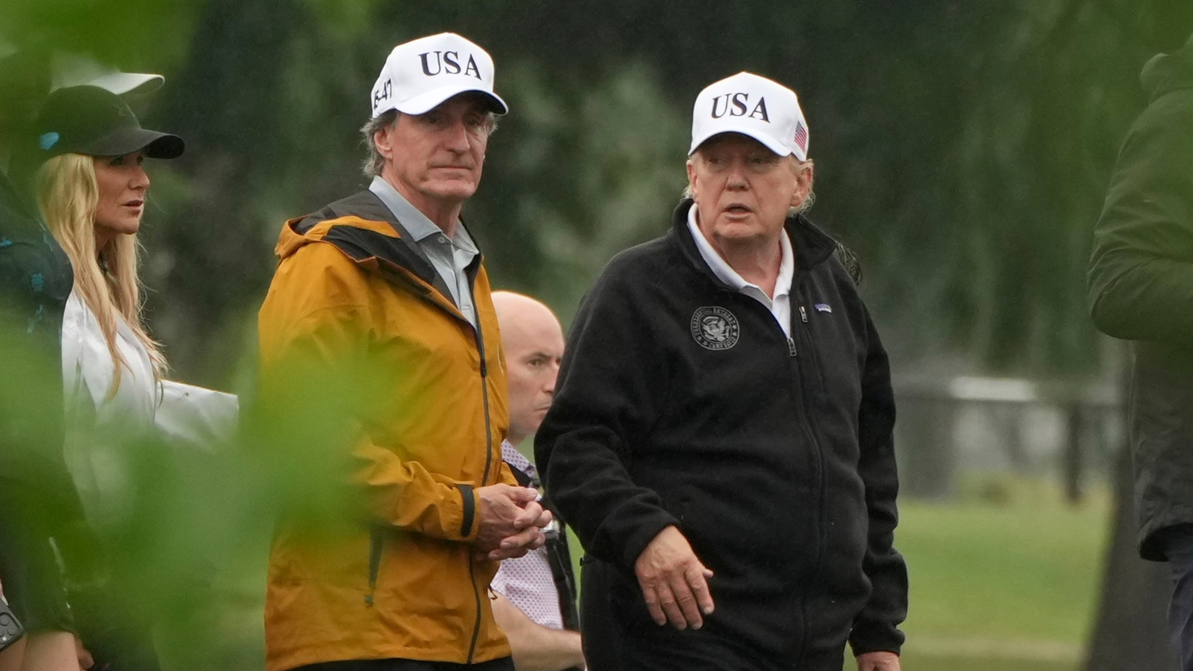 President Donald Trump, from right, and Interior Secretary Doug Burgum tour the East Potomac Park golf course, Sunday, June 28, 2026, in Washington. (AP Photo/Mark Schiefelbein)