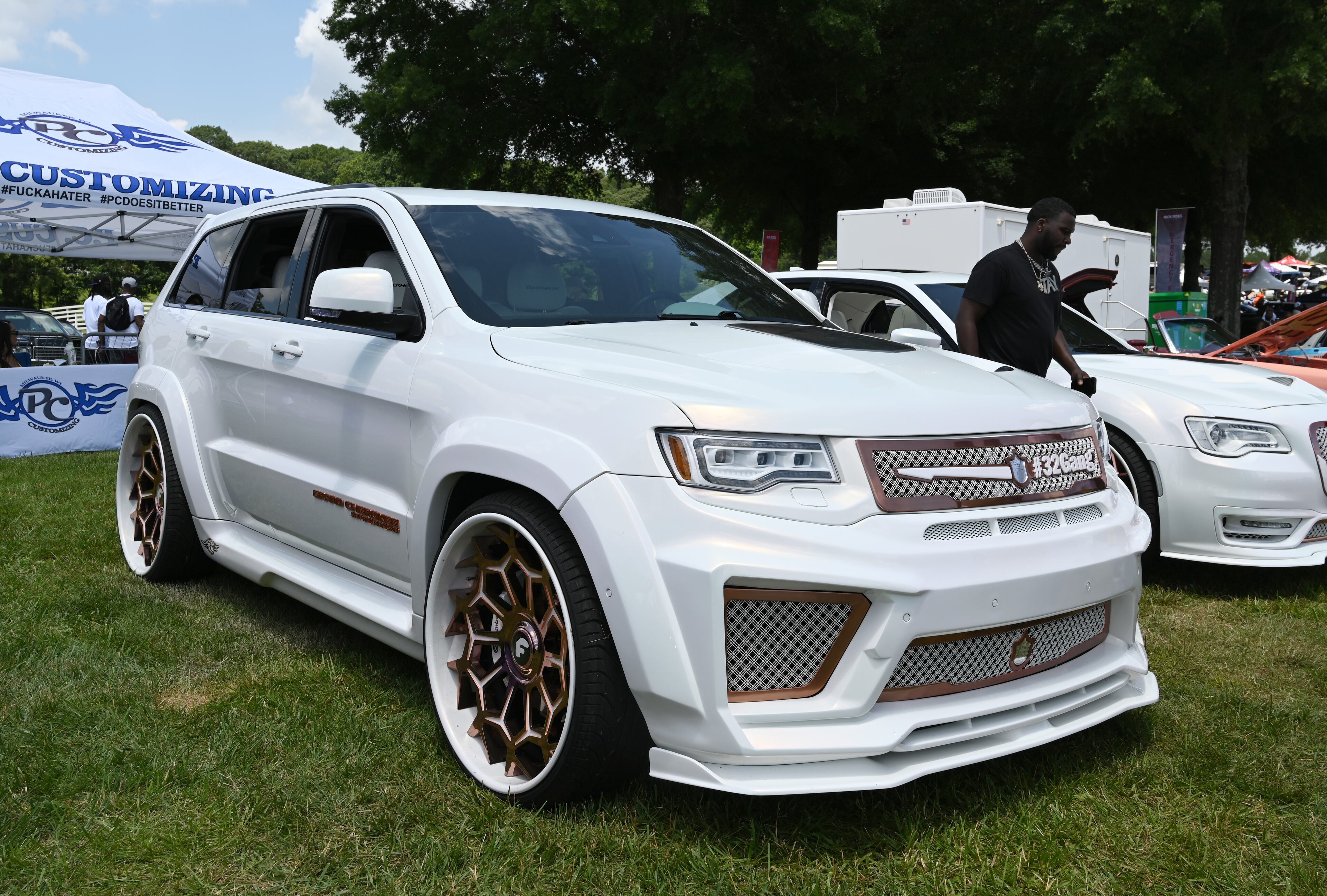 Attendees walk through some of classic/custom and luxury vehicles on Rick Ross’s property during the 4th Annual Rick Ross Car and Bike Show, Saturday, June 7, 2025, in Fayetteville. The 4th Annual Rick Ross Car and Bike Show will include a vendor market with more than 30 vendors, food trucks, fleets of classic/custom automobiles, luxury vehicles, boats, RVs and trailers on the front of the mansion. Stage performances include Plies, Ross' new signee Nino Breeze and Ross himself. (Hyosub Shin / AJC)