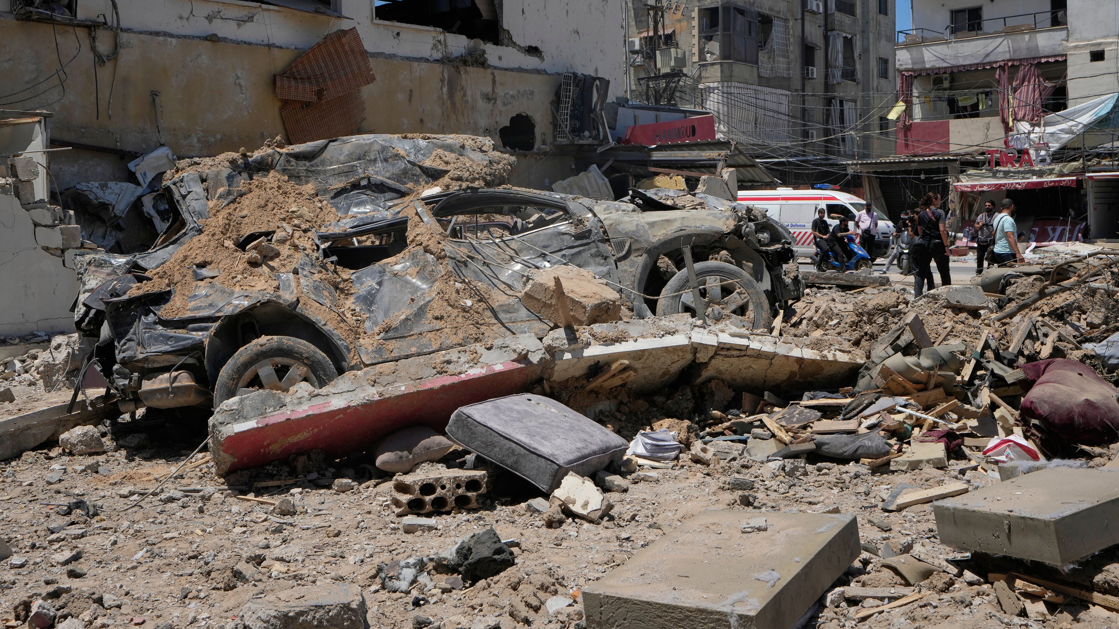 A car lies amidst debris following an Israeli airstrike in the southern port city of Tyre, Friday, June 12, 2026. (AP Photo/Mohammed Zaatari)