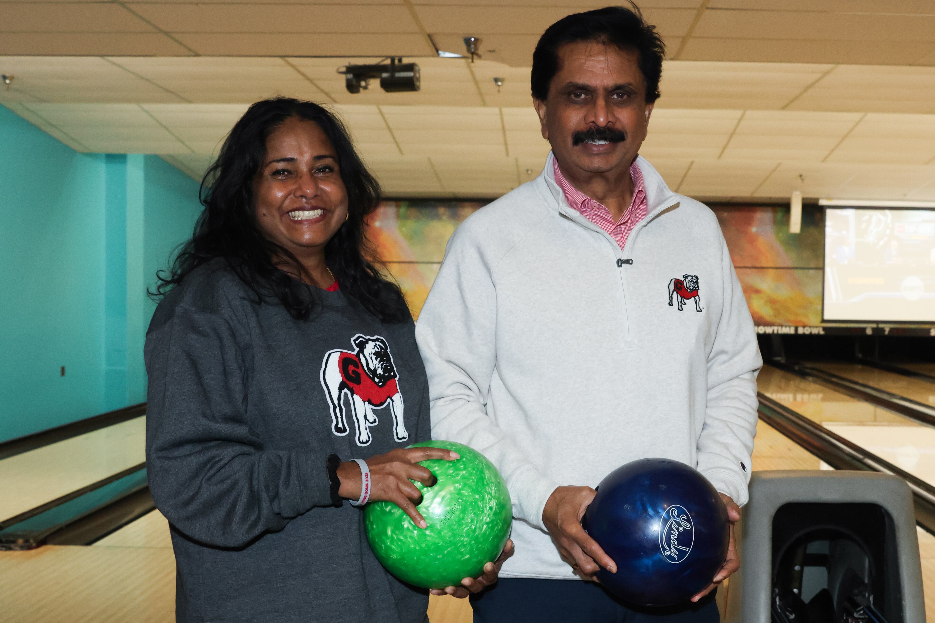 Drs. Arthi (left) and Anumantha Kanthasamy pose for a photo before the third annual Chick-fil-A Dawg Bowl fundraiser at Showtime Bowl in Athens on Wednesday, Oct. 22, 2025. Both husband and wife are UGA professors in the Department of Physiology and Pharmacology and the Isakson Center for Neurological Disease Research, the latter of which Anumantha directs. The Dawg Bowl has raised more than $2 million in the past three years for the Isakson Center’s research into Parkinson’s and Crohn’s diseases. (C.J. Bartunek for the AJC)
