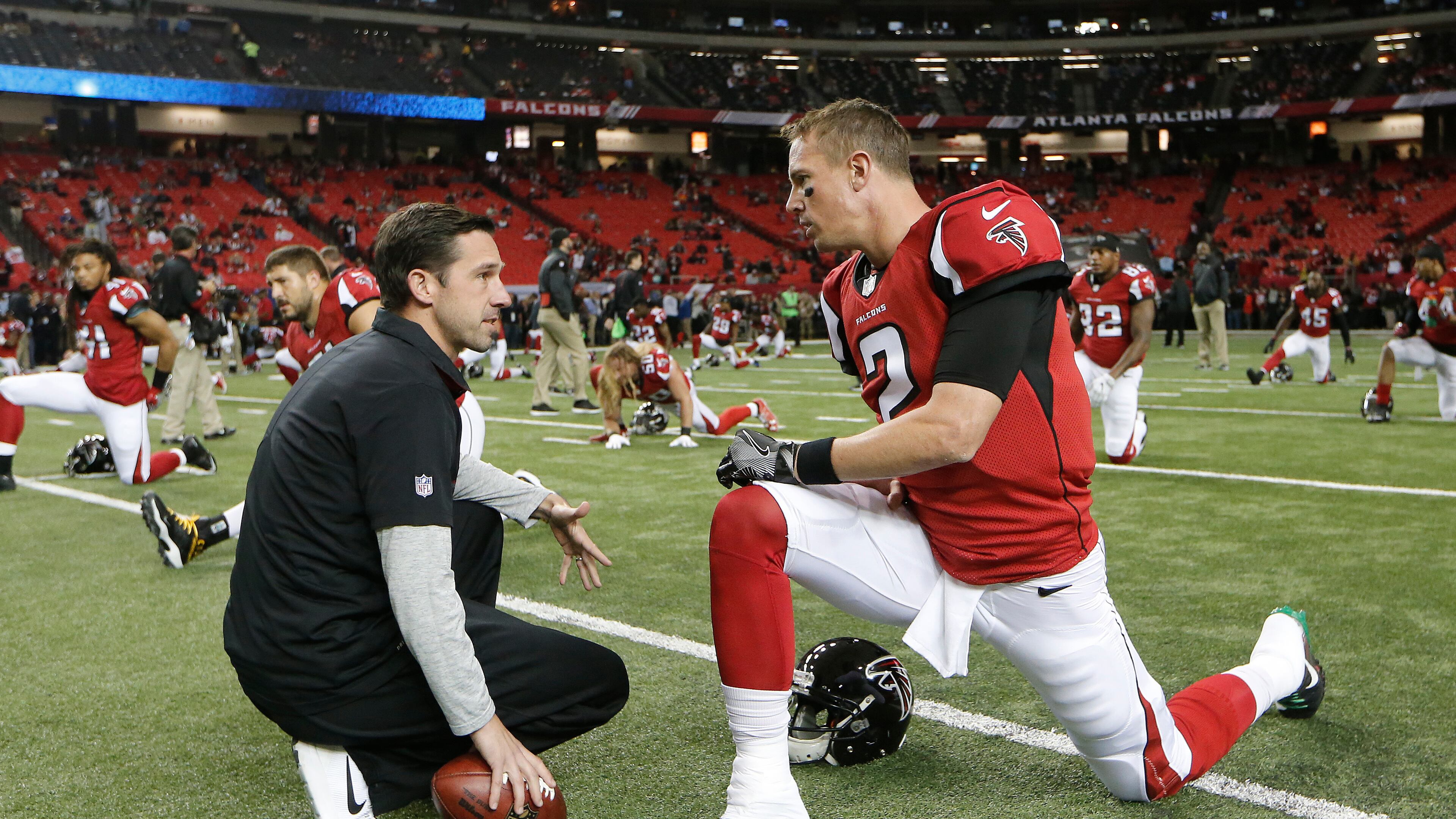 Atlanta Falcons quarterback Matt Ryan speaks with offensive coordinator Kyle Shanahan before a game between the Atlanta Falcons and the Kansas City Chiefs on Sunday, Dec. 4, 2016, in Atlanta. (AP Photo/John Bazemore)