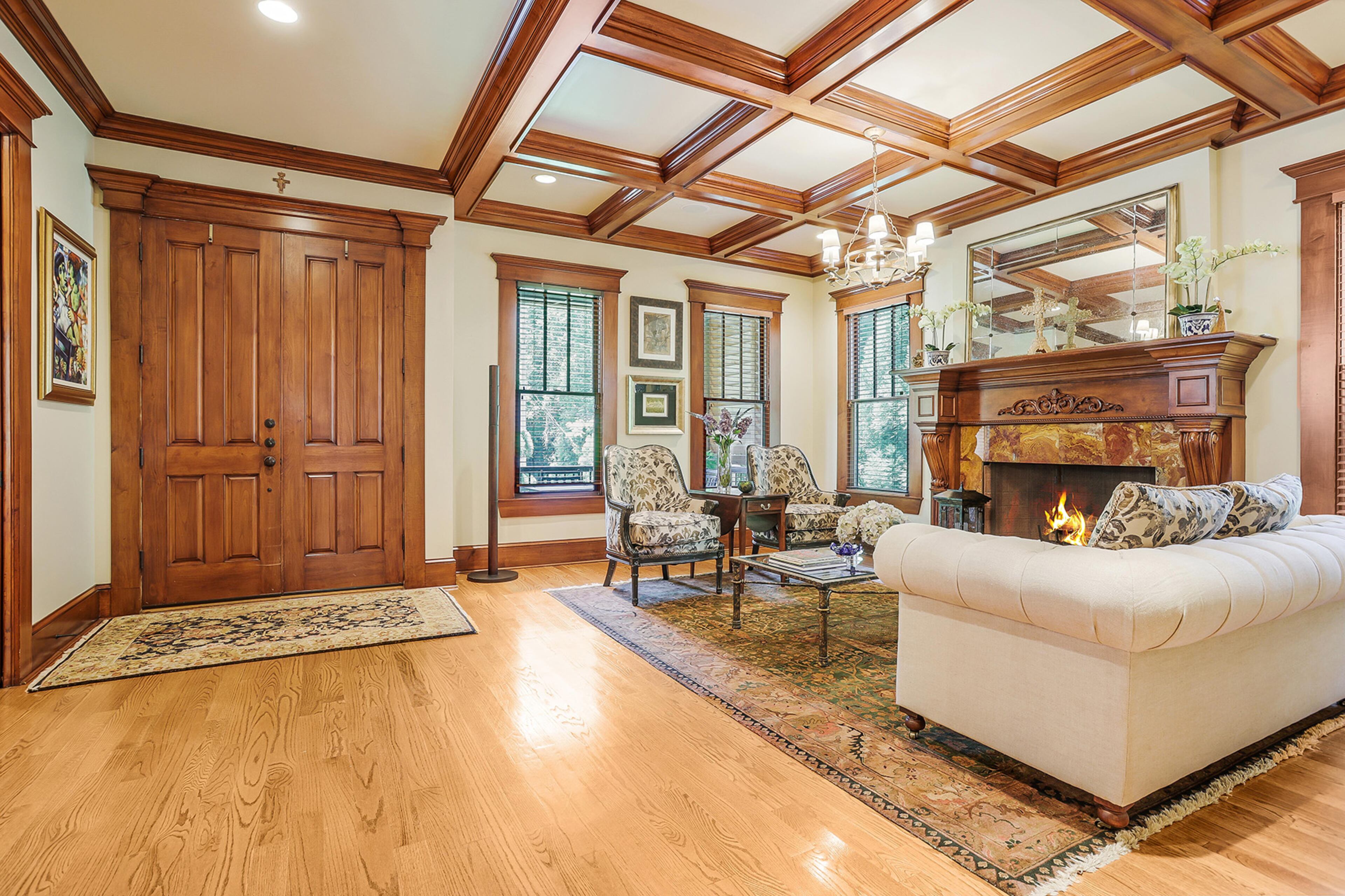 Dramatic entry with high coffered ceiling in living room. Text by Jim Cox