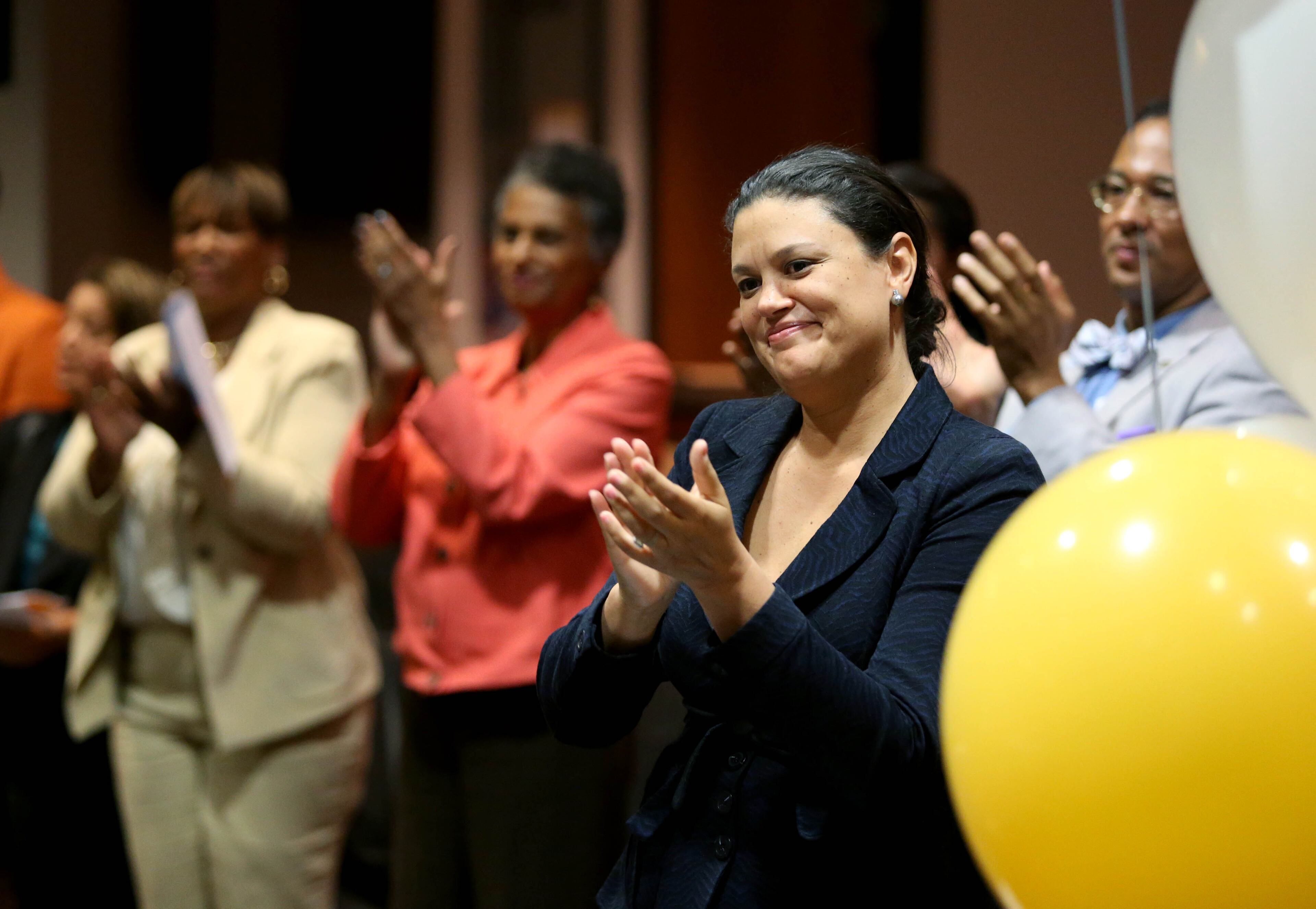 Atlanta Public Schools Superintendent Meria J. Carstarphen, right, applauds the 16 students who participated in the REACH Statewide Signing Day.