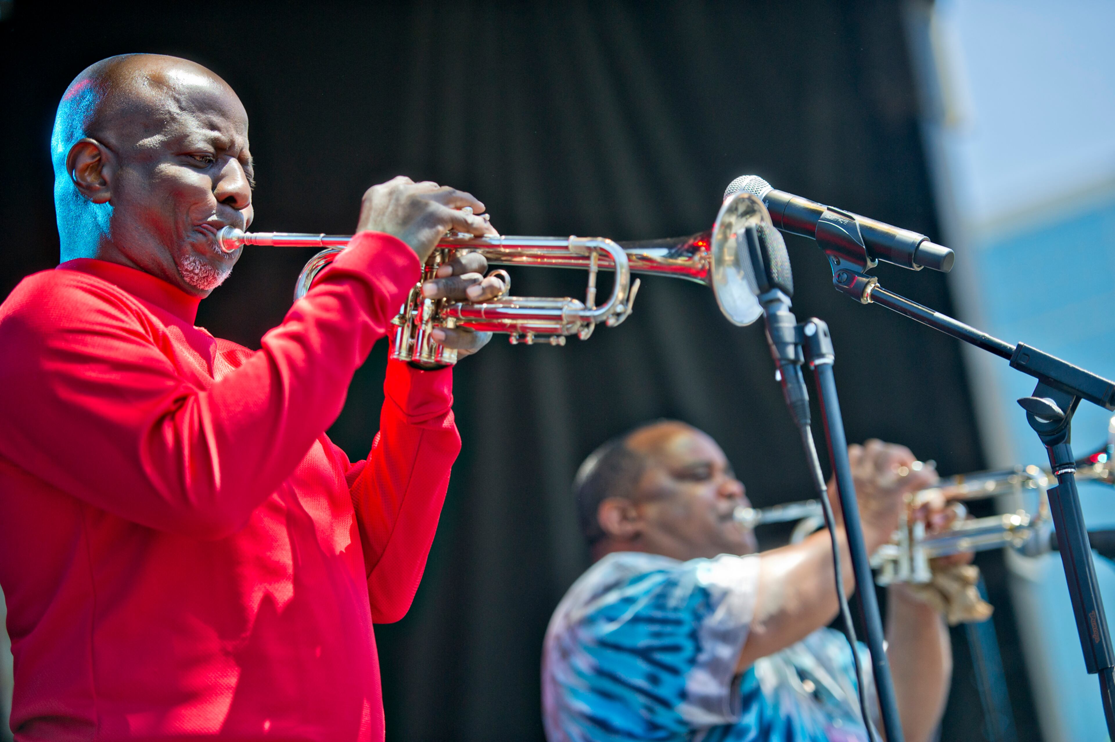 Gregory Davis (left) and Efrem Towns play their trumpets as they perform with other members of the Dirty Dozen Brass Band on stage during the Sweetwater 420 Festival at Centennial Olympic Park on Sunday, April 20, 2014.
