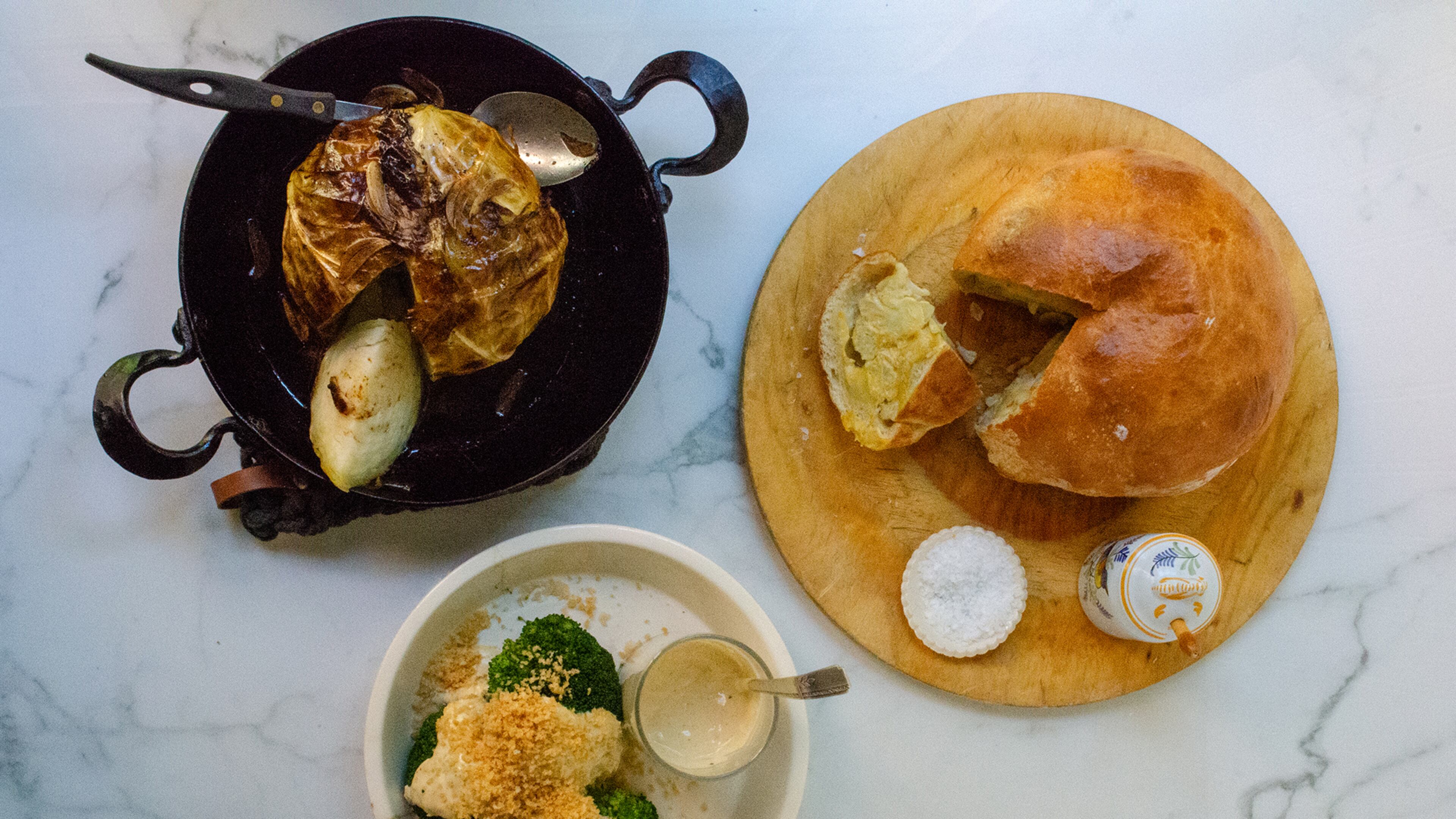 Slow Roast Cabbage (clockwise from upper left), Cauliflower en Croute and Broccoli Caesar are featured as recipes for cooking whole vegetables. (Virginia Willis for The Atlanta Journal-Constitution)