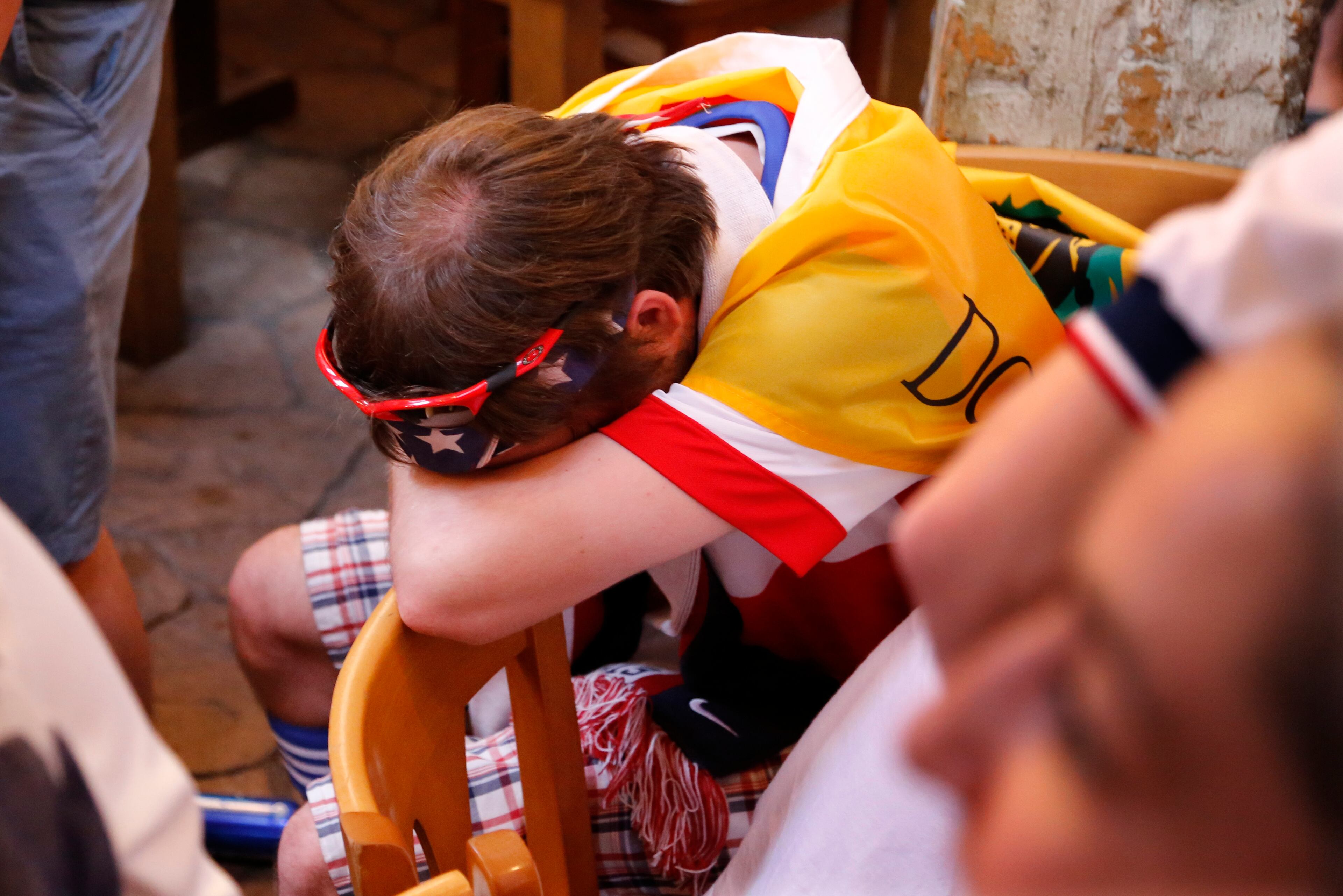 A soccer fan at The Claddagh Irish Pub in Pittsburgh reacts as Portugal scores to tie the score at 2-2 with less than one minute remaining during a World Cup soccer match against the United States in Brazil Sunday, June 22, 2014. (AP Photo/Gene J. Puskar)