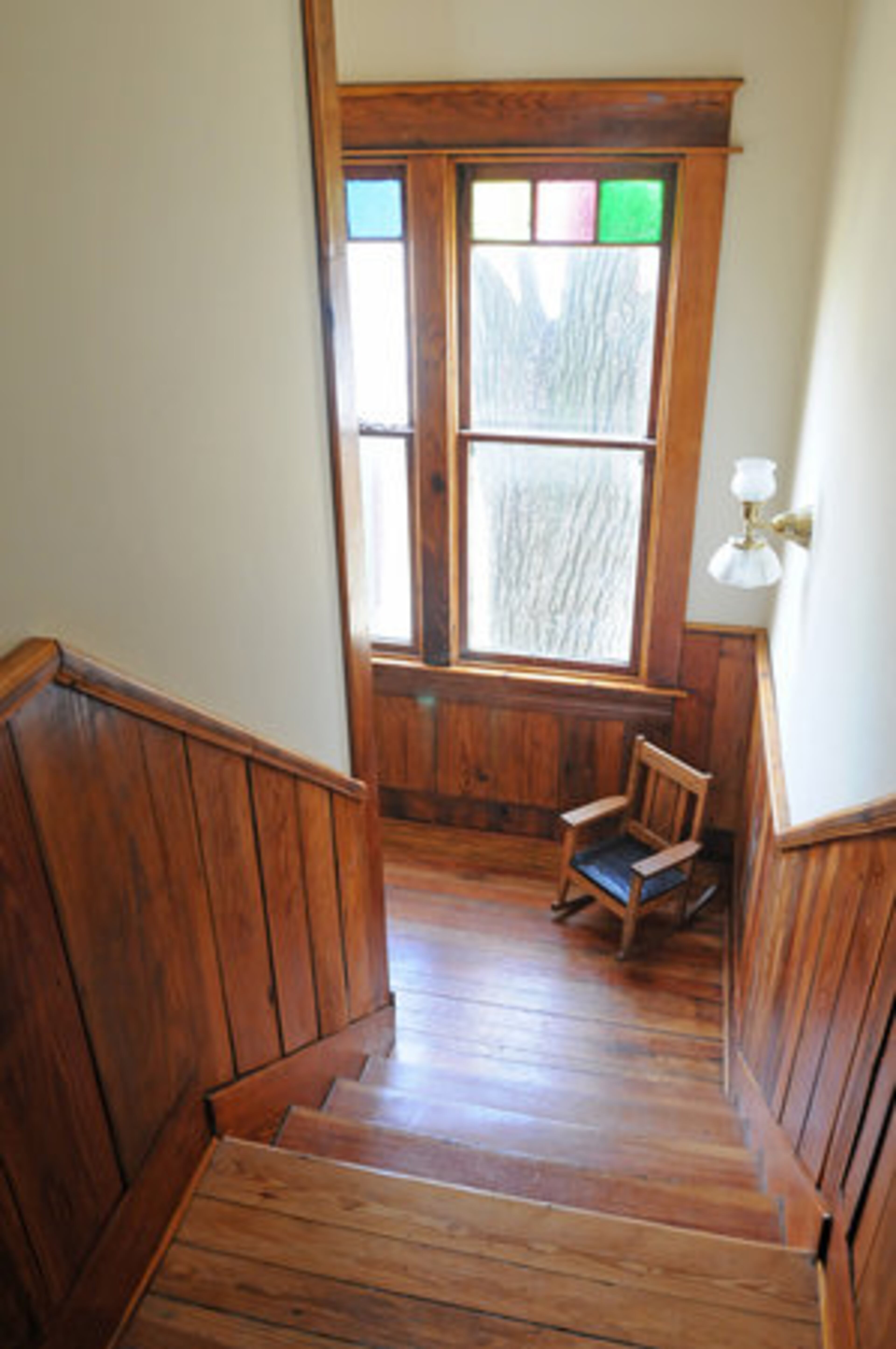 The upstairs hallway originally was plaster, but Walker and her friends were getting the walls smudged with hand prints. "I had antique heart of pine sheathing boards from a roof in Virginia Highlands and so I ran them through a planer and installed them as wainscot to solve that problem, " said Kara O'Brien.