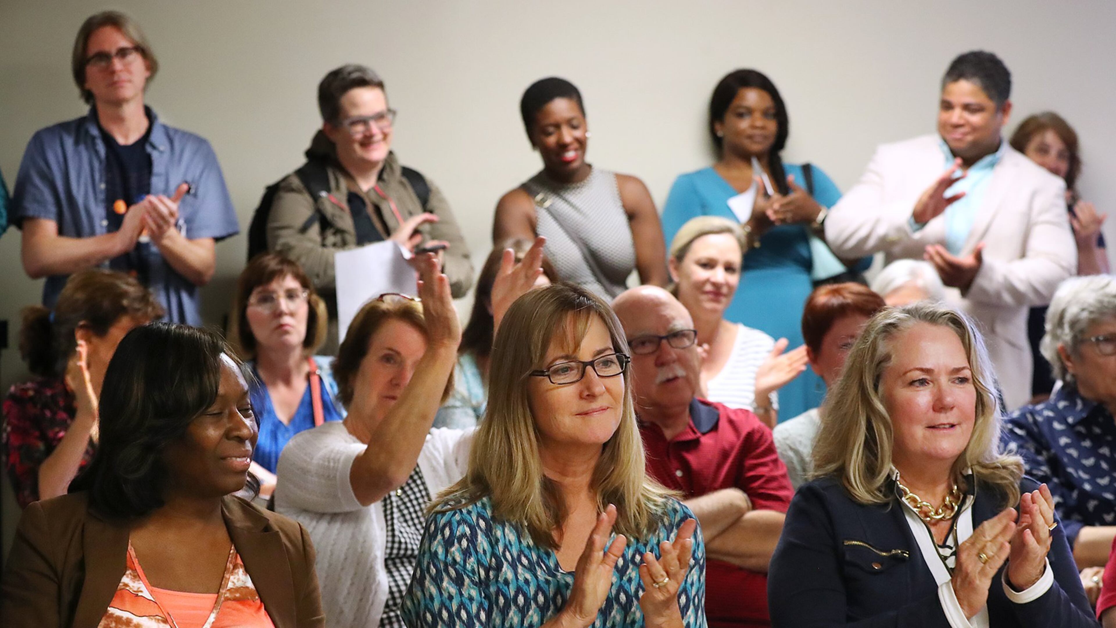 A standing room only crowd applaudes as the DeKalb Elections Board votes to open three more early voting locations to bring the total to five in anticipation of the runoff for the 6th Congressional District after hearing public comments on Thursday, May 11, 2017, in Decatur. Curtis Compton/ccompton@ajc.com