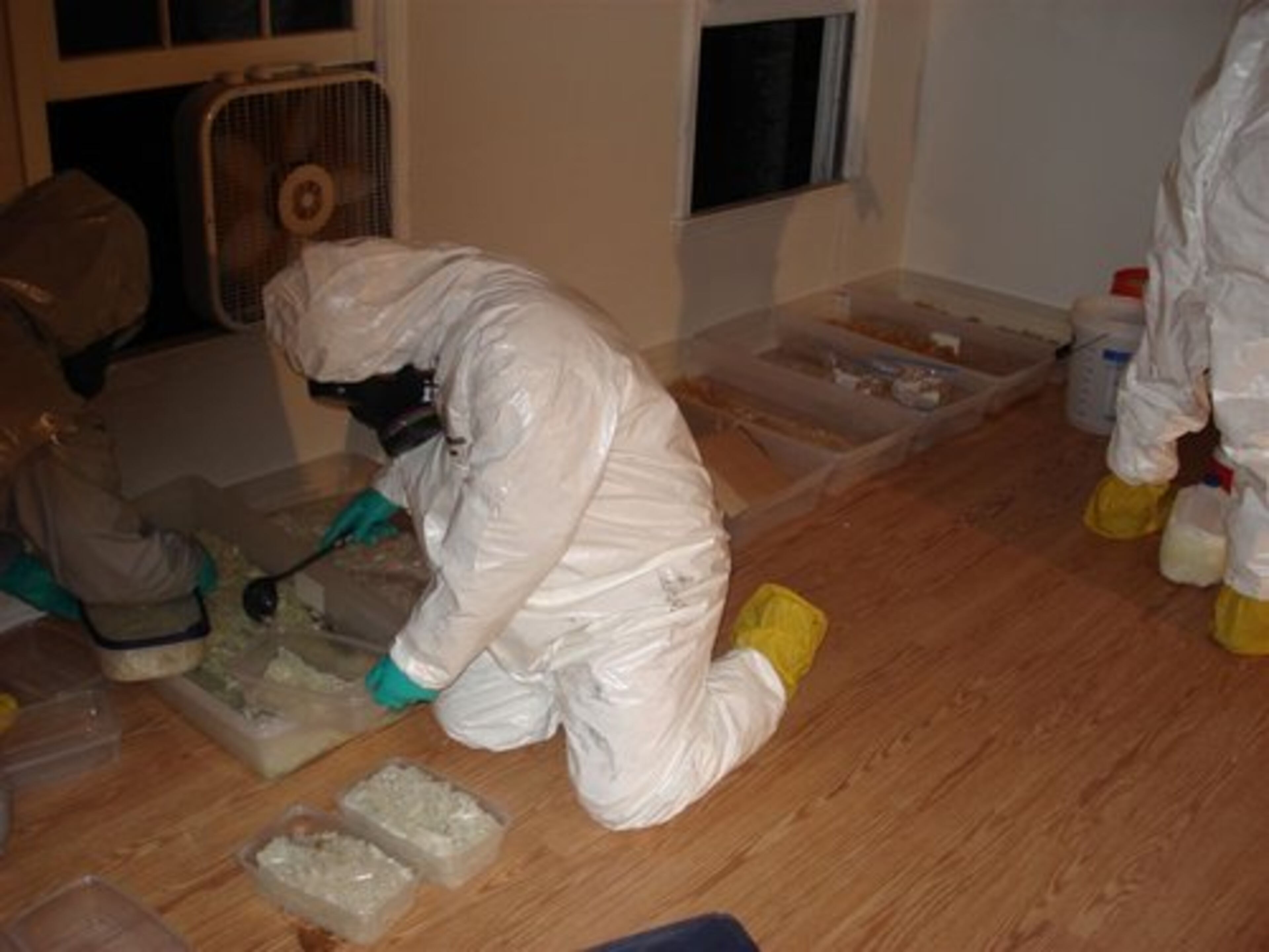 Authorities in hazmat suits spent the night removing items from a suspected drug house in Norcross. DEA agents assisted Norcross and Gwinnett County police at the home.