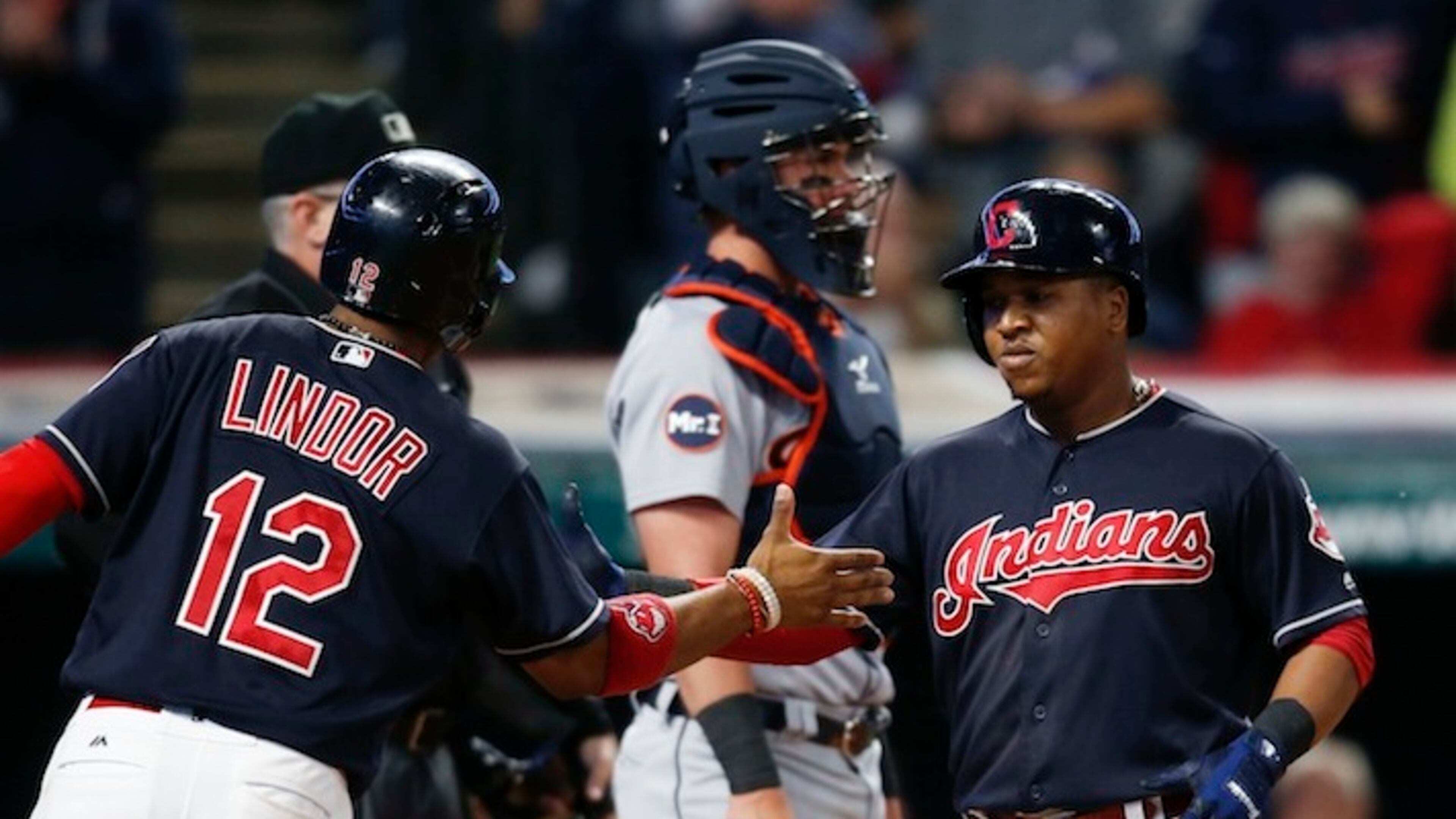 Cleveland Indians' Jose Ramirez gets congratulations from Francisco Lindor (12) after hitting a two run home run off Detroit Tigers starting pitcher Myles Jaye as catcher James McCann stands in the background during the fourth inning in a baseball game, Monday, Sept. 11, 2017, in Cleveland. (AP Photo/Ron Schwane)