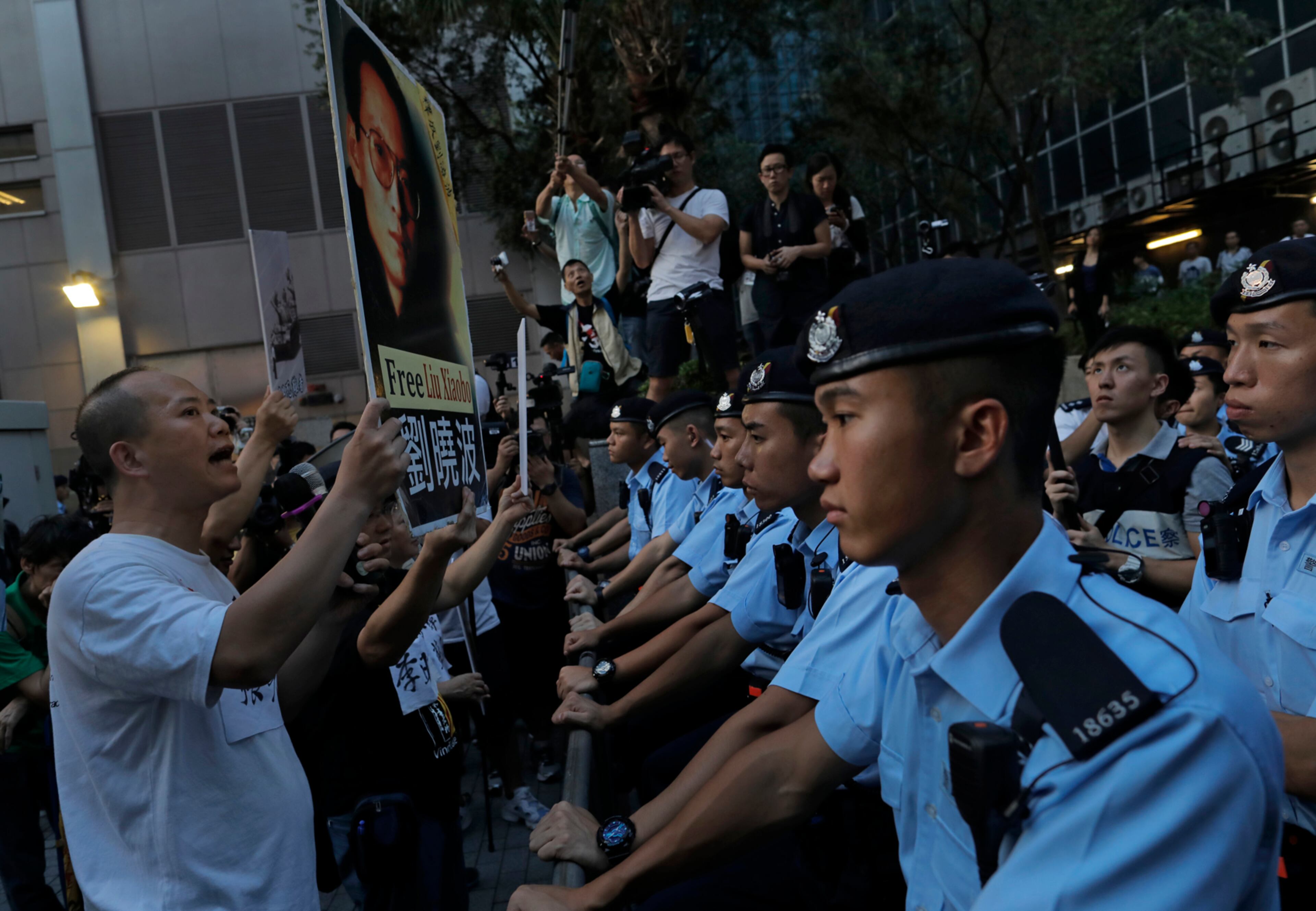 Pro-democracy activists hold photos of detained Nobel Peace Prize Laureate Liu Xiaobo during a protest in Hong Kong, Friday, June 30, 2017. Chinese President Xi Jinping landed in Hong Kong Thursday to mark the 20th anniversary of Beijing taking control of the former British colony, accompanied by a formidable layer of security as authorities showed little patience for pro-democracy protests. (AP Photo/Vincent Yu)