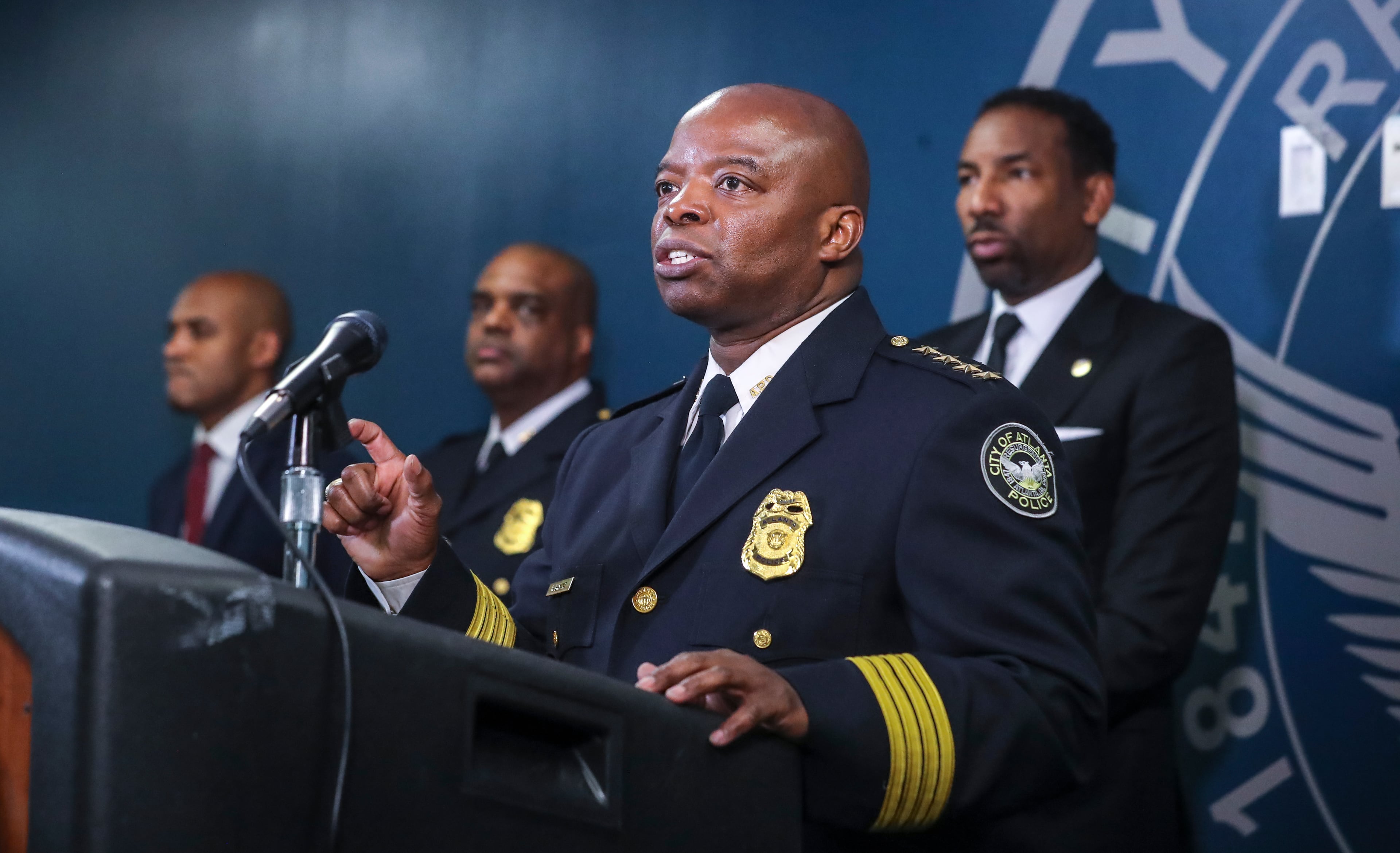 March 15, 2022 Atlanta: Atlanta police chief Rodney Bryant speaks at the podium as police command staff (left to right) Lt. Ralph Woolfolk, commander of Atlanta police's homicide unit, Deputy Chief Charles Hampton and Mayor Andre Dickens spoke about how Atlanta’s homicide detectives have made arrests in 72% of this year’s killings on Tuesday, March 15, 2022. (John Spink / John.Spink@ajc.com)