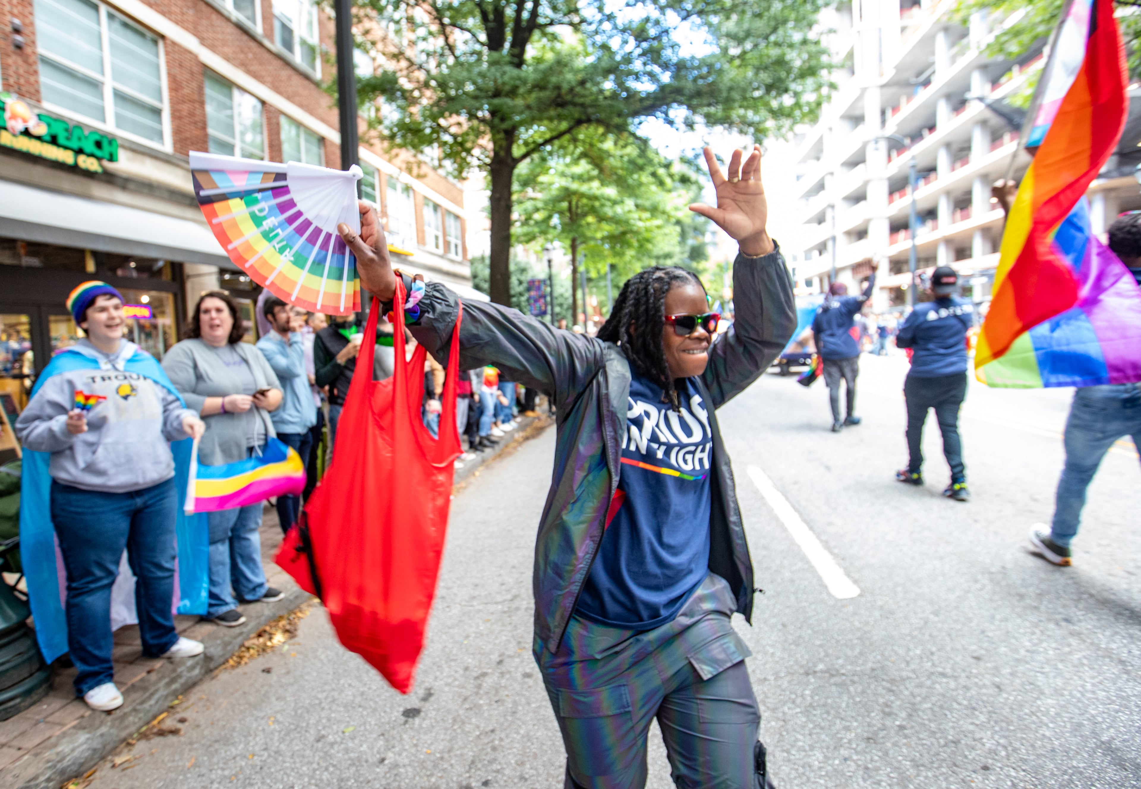 Amarachi Mazariegos gets into the spirit with Delta during the annual Pride Parade as it runs up Peachtree Street to 10th Street and into Piedmont Park in Atlanta on Sunday, Oct 15, 2023. (Jenni Girtman for The Atlanta Journal-Constitution)