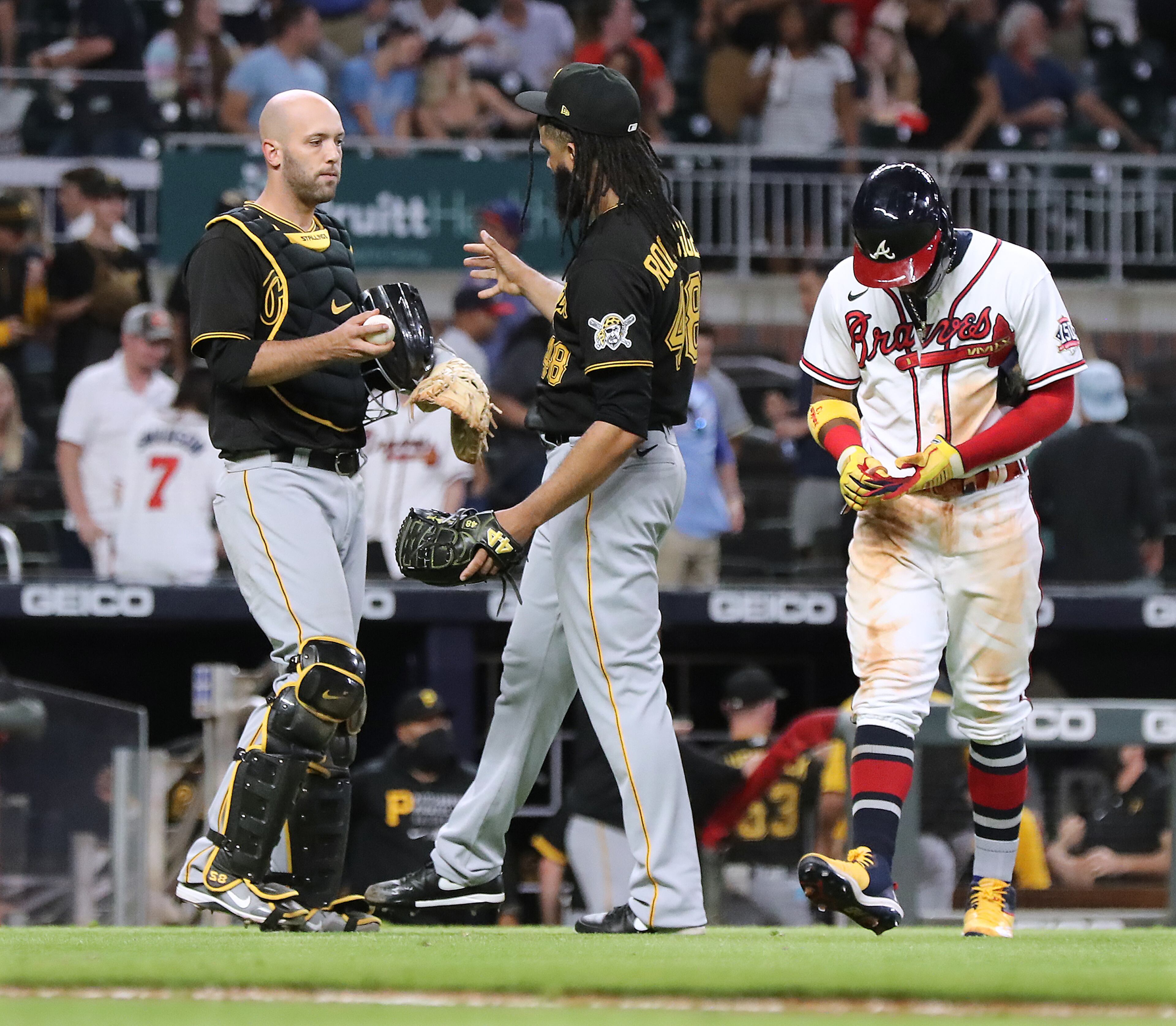 Braves base runner Ronald Acuna walks off the field dejected from third base as Pittsburgh Pirates pitcher Richard Rodriguez and catcher Jacob Stallings celebrate a 6-4 victory over the Braves in the 10th inning of a MLB baseball game on Thursday, May 20, 2021, in Atlanta. “Curtis Compton / Curtis.Compton@ajc.com”