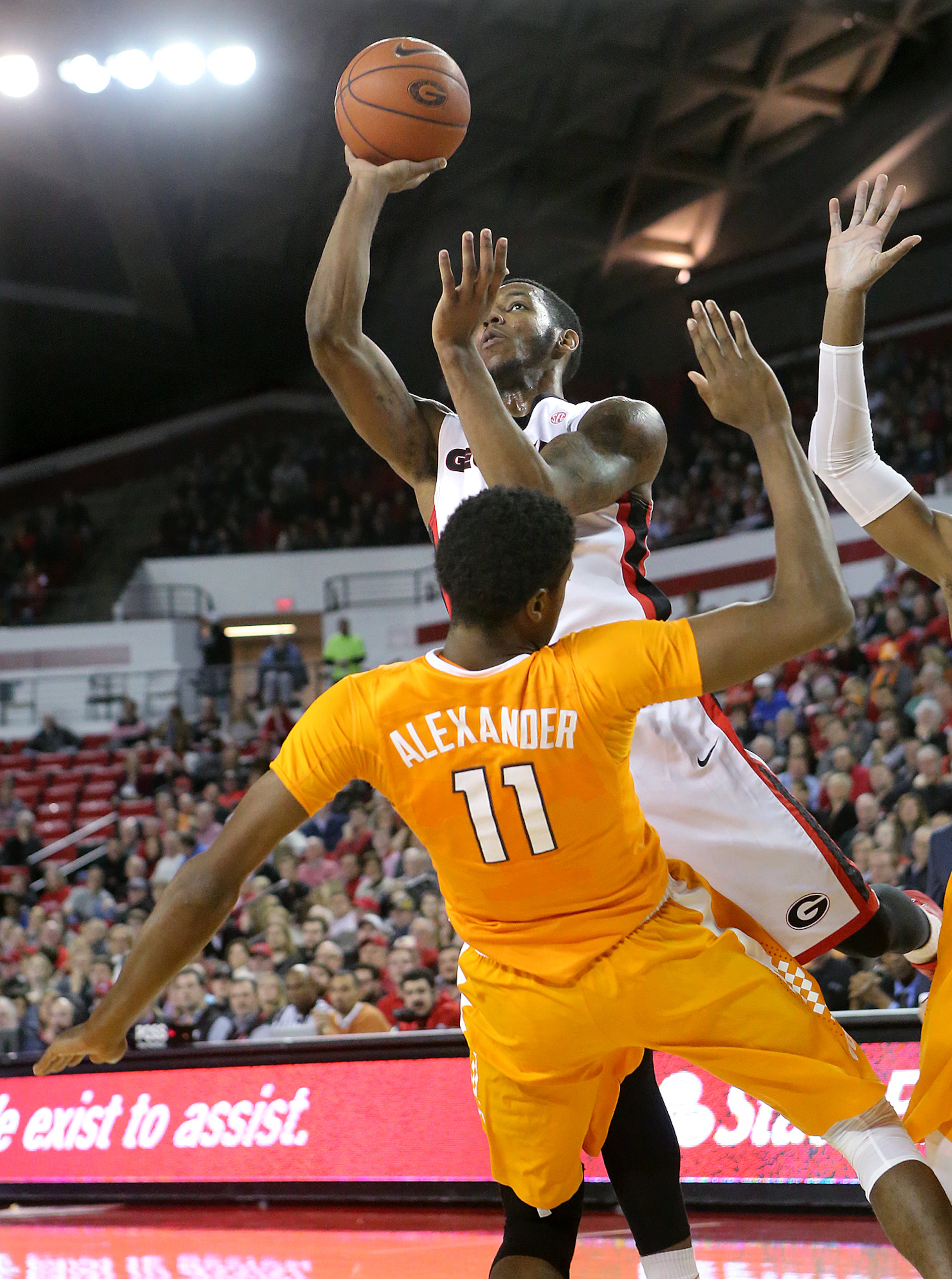 Georgia guard Charles Mann knocks Tennessee forward Kyle Alexander to the hardwood for an offensive foul in a basketball game on Wednesday, Jan. 13, 2016, in Athens. Curtis Compton / ccompton@ajc.com