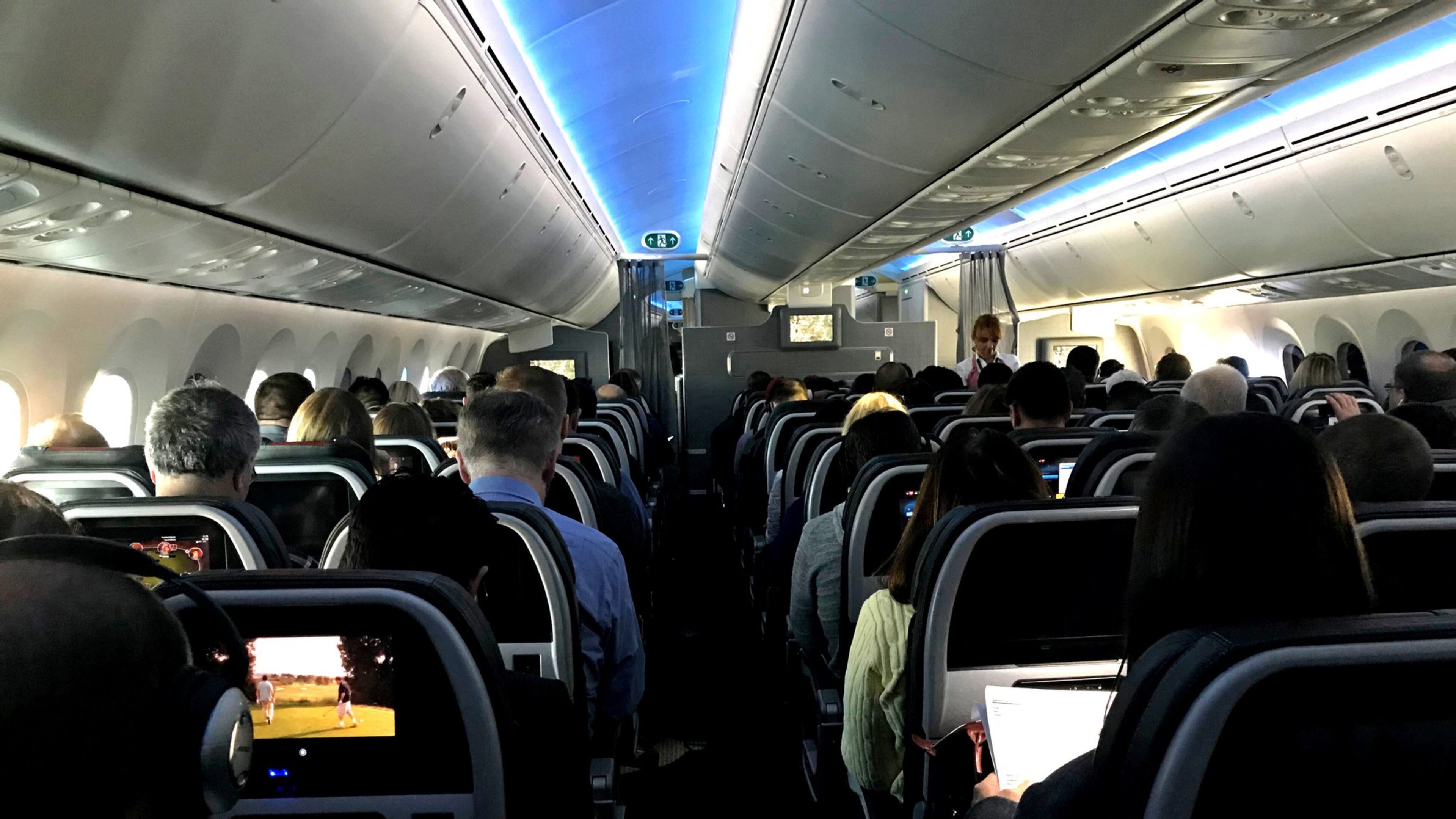 Main cabin passengers pass the time aboard American Airlines flight 2331, a Boeing 787-800 Dreamliner, an route from Chicago O’Hare International Airport to Dallas/Fort Worth International Airport, on March 5, 2018. (Jerome Adamstein/Los Angeles Times/TNS)