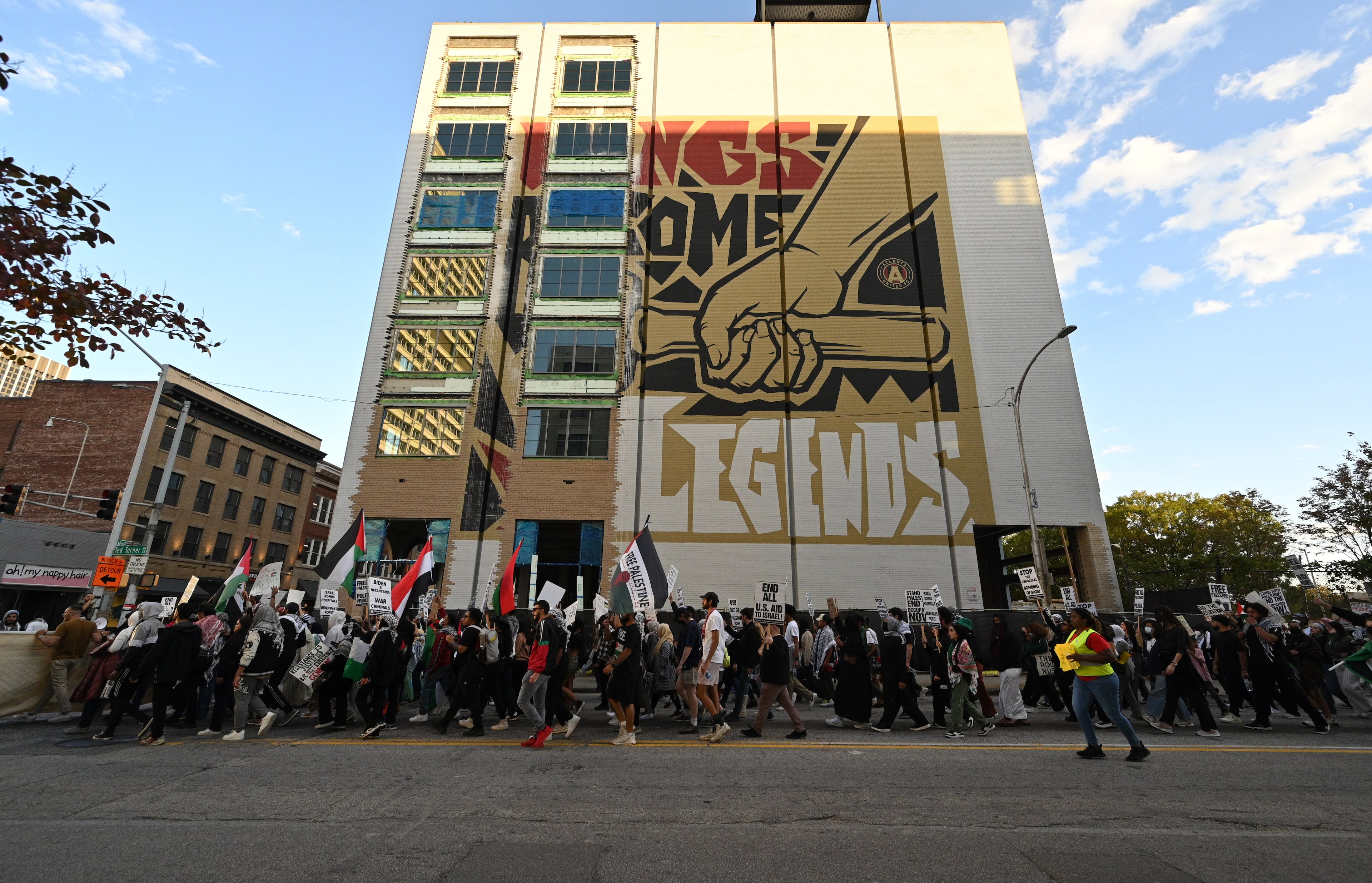 Pro-Palestinian supporters holding signs march in downtown during a pro-Palestinian rally, Friday, October 20, 2023, in Atlanta. Hundreds gathered in downtown Atlanta to march in support of Palestine. (Hyosub Shin / Hyosub.Shin@ajc.com)