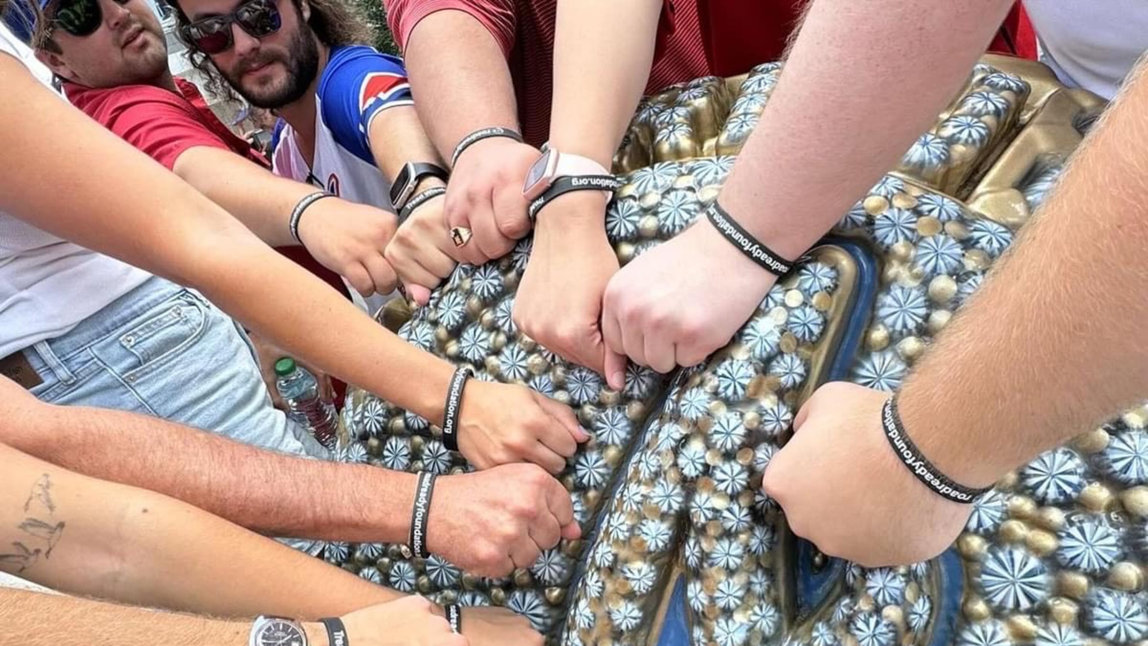 Attendees of the first annual Jackson Charles Bebiak Fundraiser, hosted by the Road Ready Foundation and Phi Sigma Kappa, show their tire tread-awareness bracelets at a 2024 Atlanta Braves game at Truist Park. (Courtesy of Road Ready Foundation)