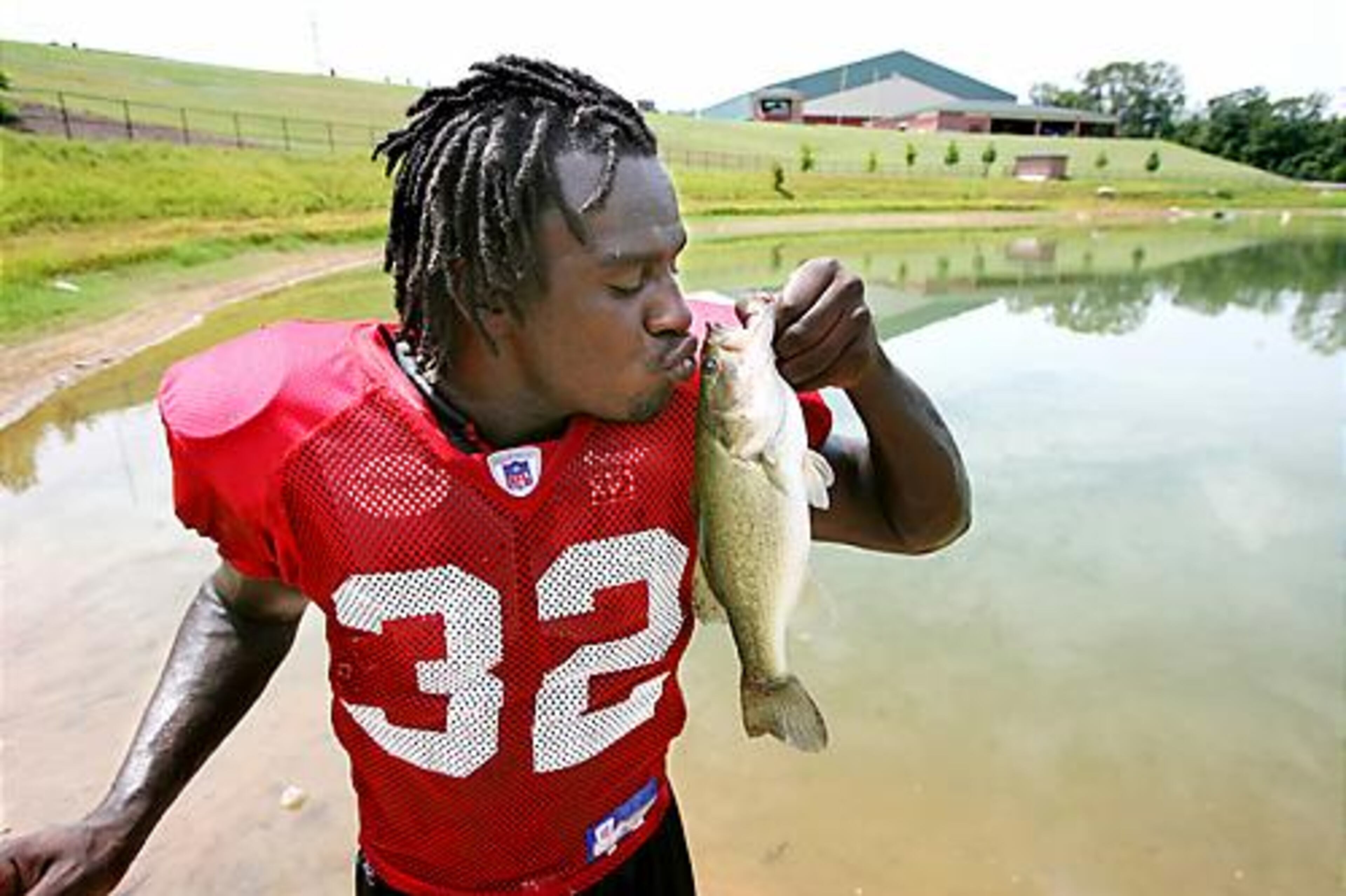 Second-year running back Jerious Norwood is an avid hunter and fisherman from Mississippi. He makes a catch in a pond near the Falcons facility in Flowery Branch.