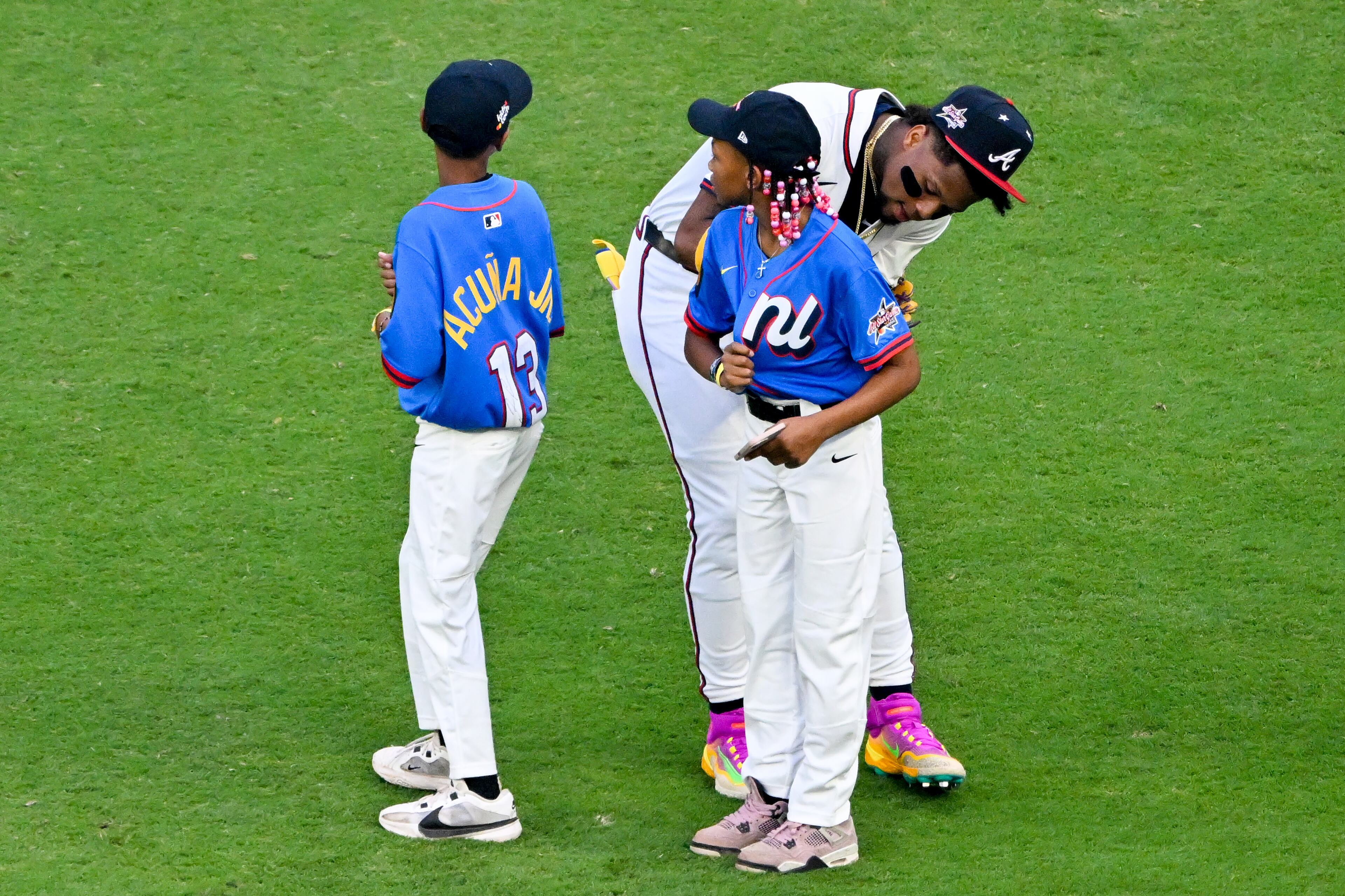 The National League's Ronald Acuña Jr. of the Atlanta Braves signs autographs before taking the field for the MLB All-Star Game at Truist Park in Atlanta on Tuesday, July 15, 2025. (Hyosub Shin/AJC)