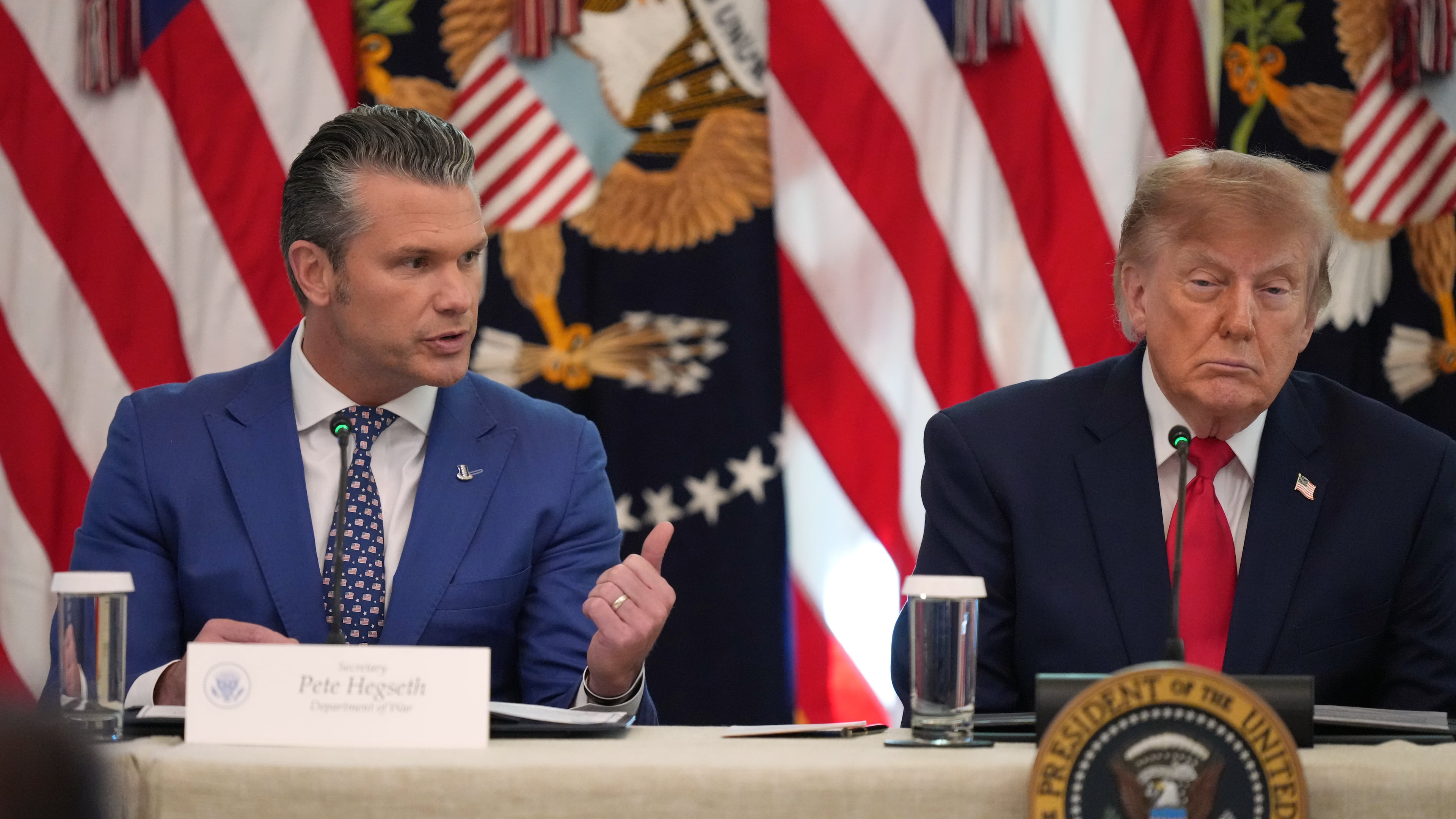 President Donald Trump listens as Defense Secretary Pete Hegseth speaks at a roundtable event in the East Room of the White House, Wednesday, Oct. 21, 2026, in Washington. (AP Photo/Alex Brandon)