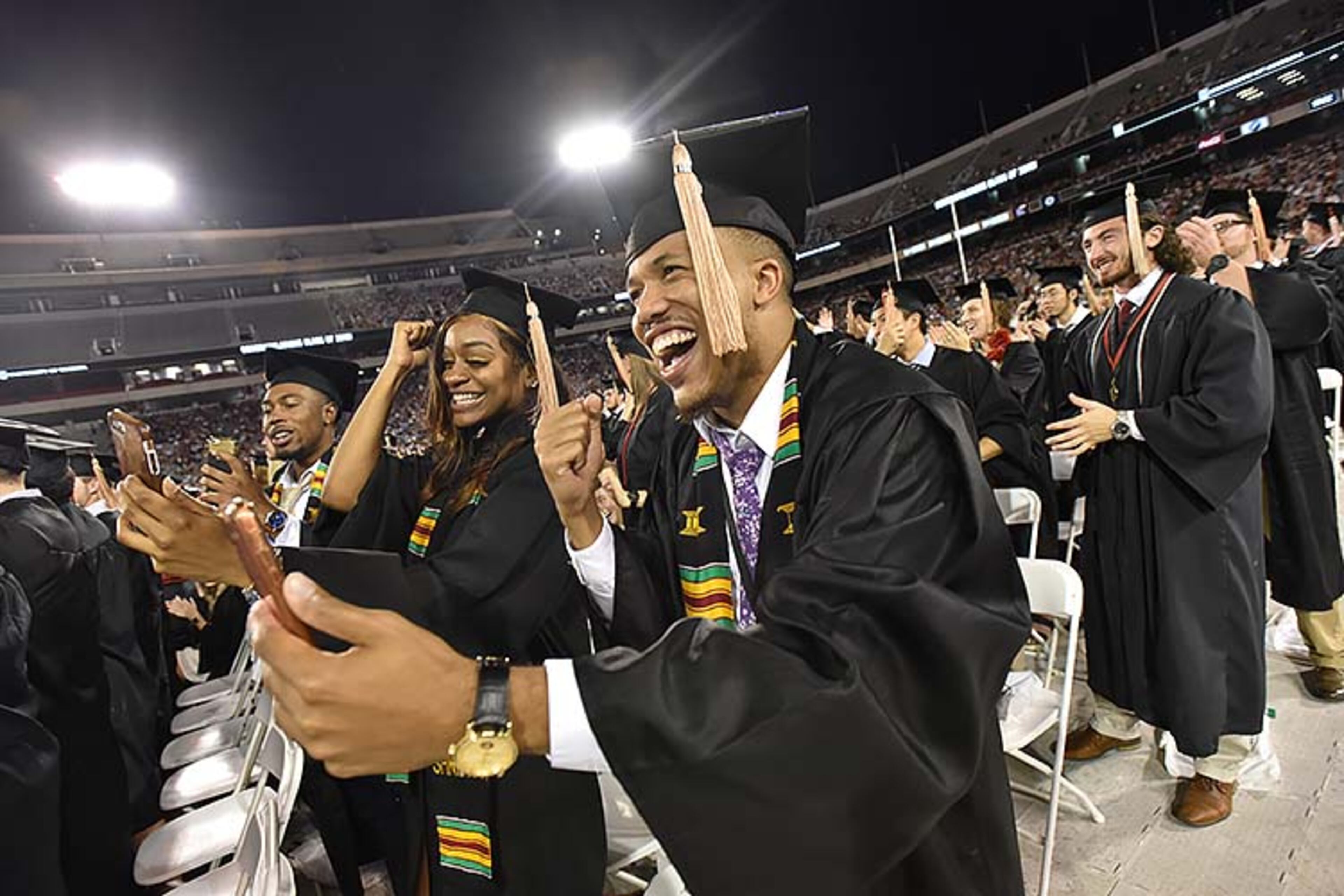 May 10, 2019 Athens - Miles Cleveland (center) and Clarissa Marseille react as they move their tassels during UGA's 2019 spring undergraduate commencement ceremony at Sanford Stadium in Athens on Friday, May 10, 2019. HYOSUB SHIN / HSHIN@AJC.COM
