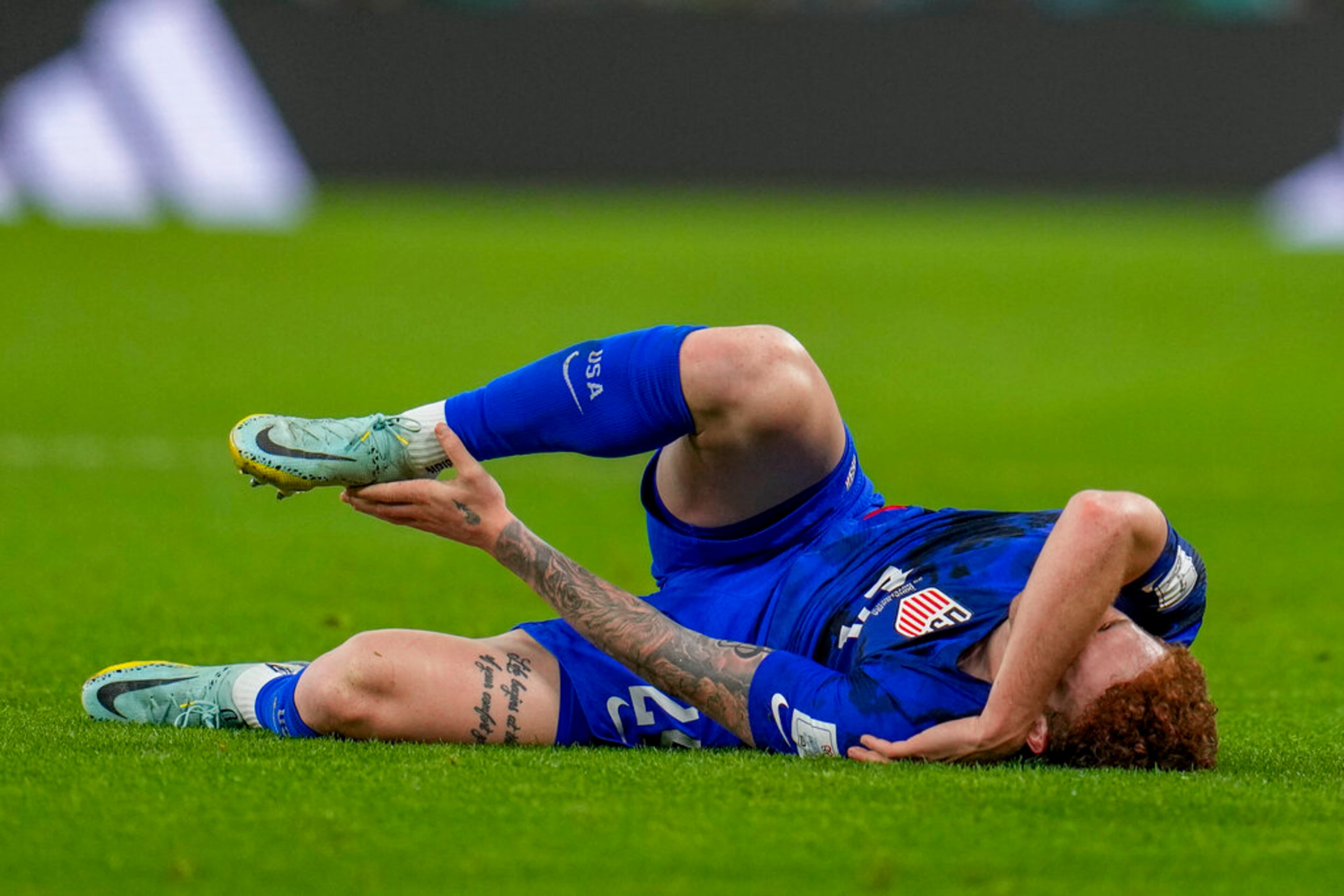 Josh Sargent of the United States is injured during the World Cup group B soccer match between Iran and the United States at the Al Thumama Stadium in Doha, Qatar, Tuesday, Nov. 29, 2022. (AP Photo/Ricardo Mazalan)