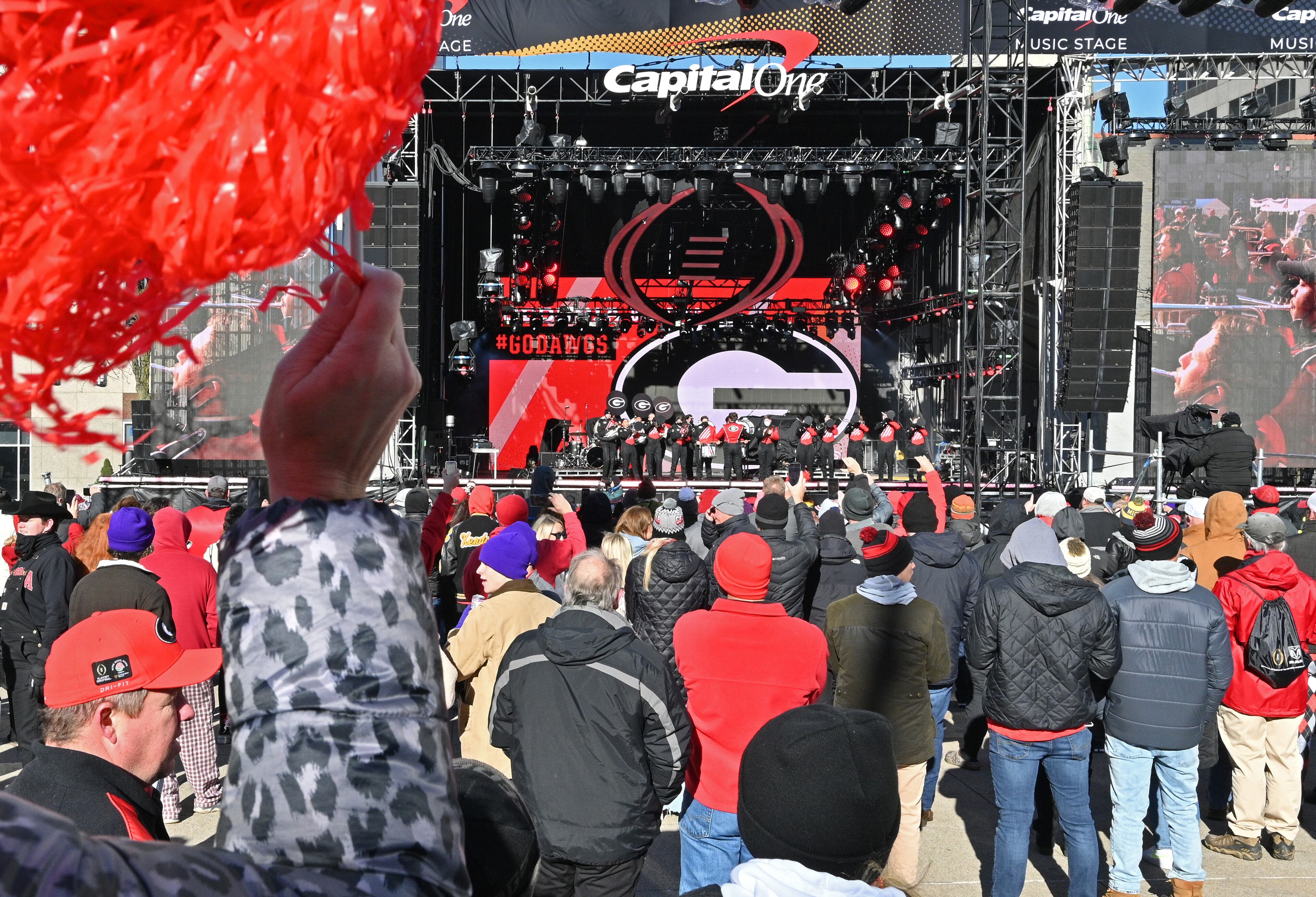 Georgia fans cheer as Georgia Redcoat Marching Band performs during Allstate Championship Tailgate event at Monument Circle prior to the 2022 College Football Playoff National Championship Game at Lucas Oil Stadium in Indianapolis on Monday, January 10, 2022. (Hyosub Shin / Hyosub.Shin@ajc.com)