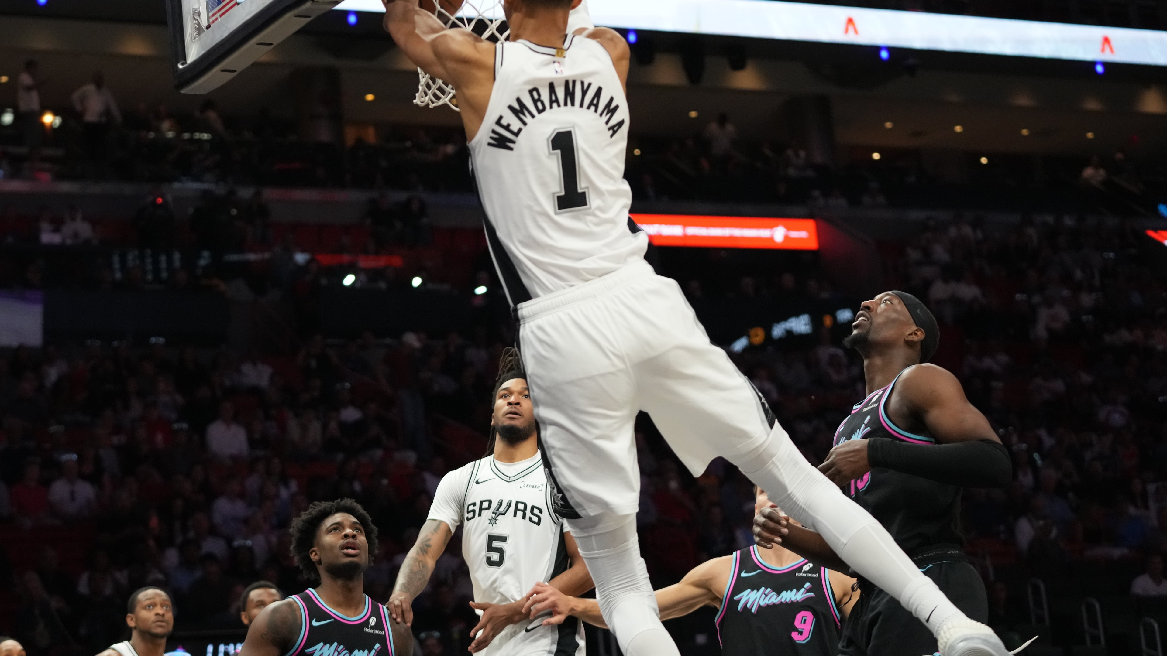 San Antonio Spurs forward Victor Wembanyama (1) dunks over Miami Heat center Bam Adebayo, right, during the first half of an NBA basketball game, Monday, March 23, 2026, in Miami. (AP Photo/Lynne Sladky)