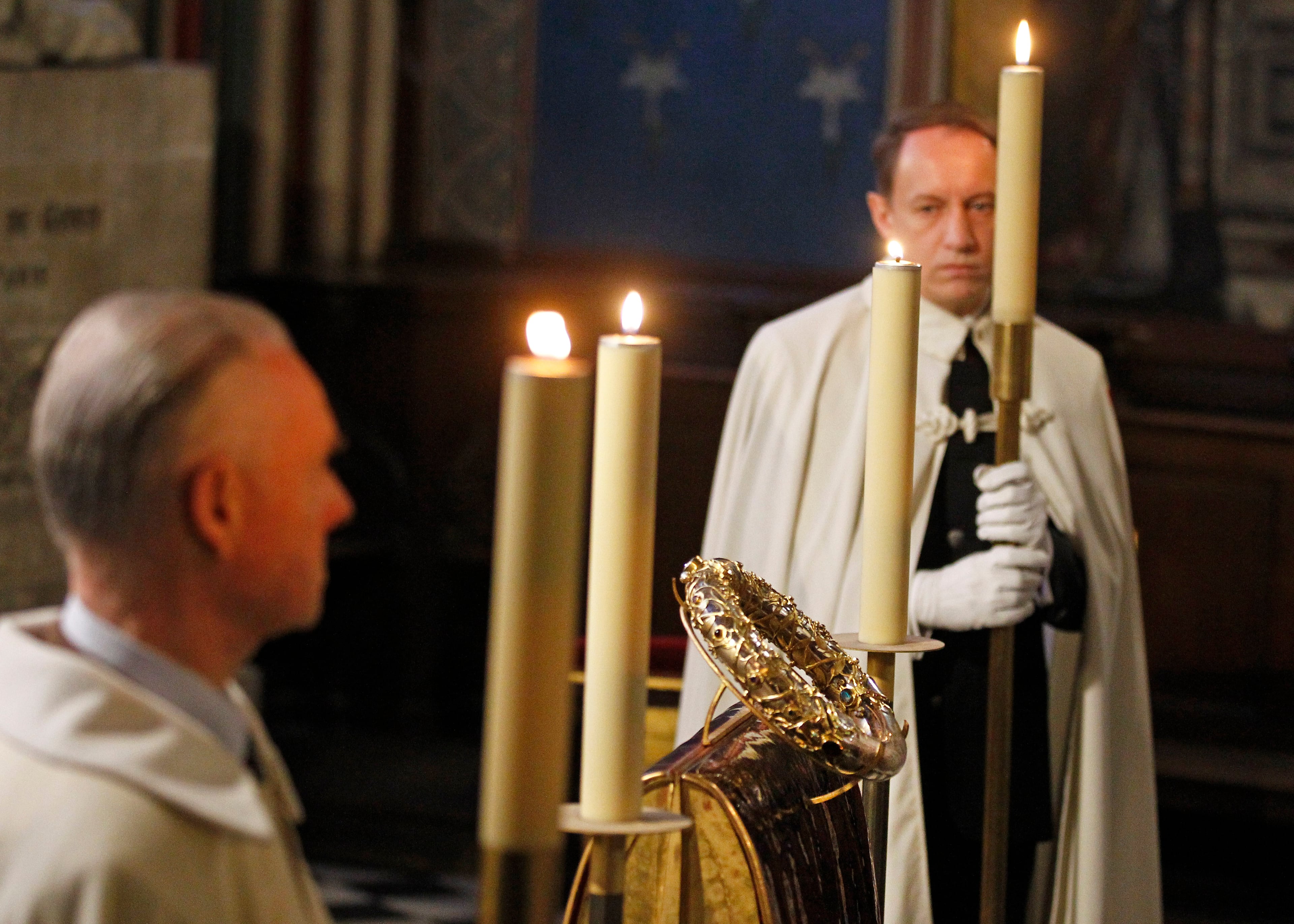 A knight of the Order of the Holy Sepulchre stands near a crown of thorns which was believed to have been worn by Jesus Christ and which was bought by King Louis IX in 1239 is presented at Notre Dame Cathedral in Paris, Friday March 21, 2014. To mark the 800th anniversary of Louis IX's christening, the crown of thorns will be displayed outside Notre Dame, at the Collegiate Church of Poissy, where King Louis IX was christened. (AP Photo/Remy de la Mauviniere)
