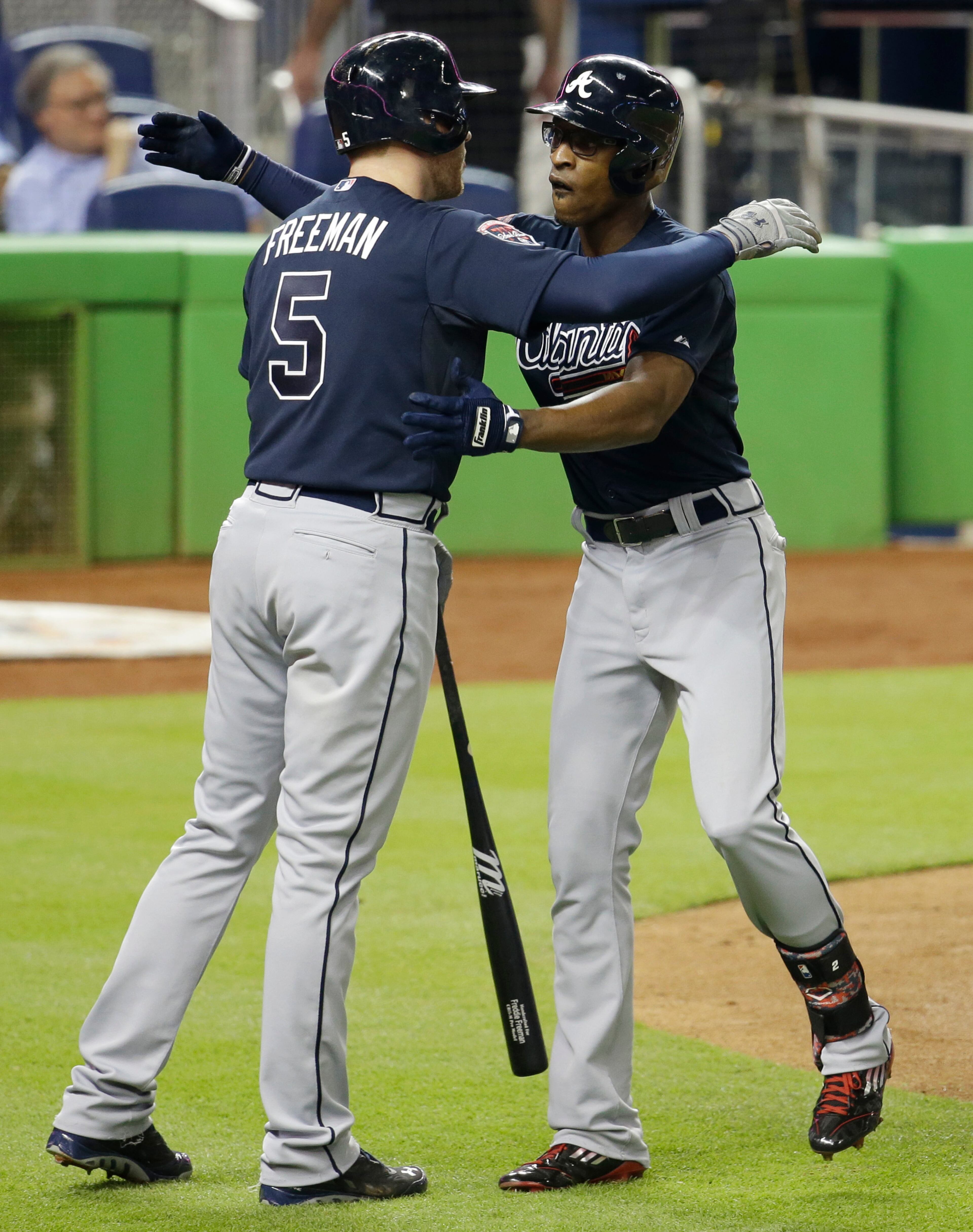 Atlanta Braves' B.J. Upton, right, is met by Freddie Freeman (5) at the plate after hitting a three-run home run in the third inning of a baseball game against the Miami Marlins, Thursday, May 1, 2014, in Miami. (AP Photo/Lynne Sladky)