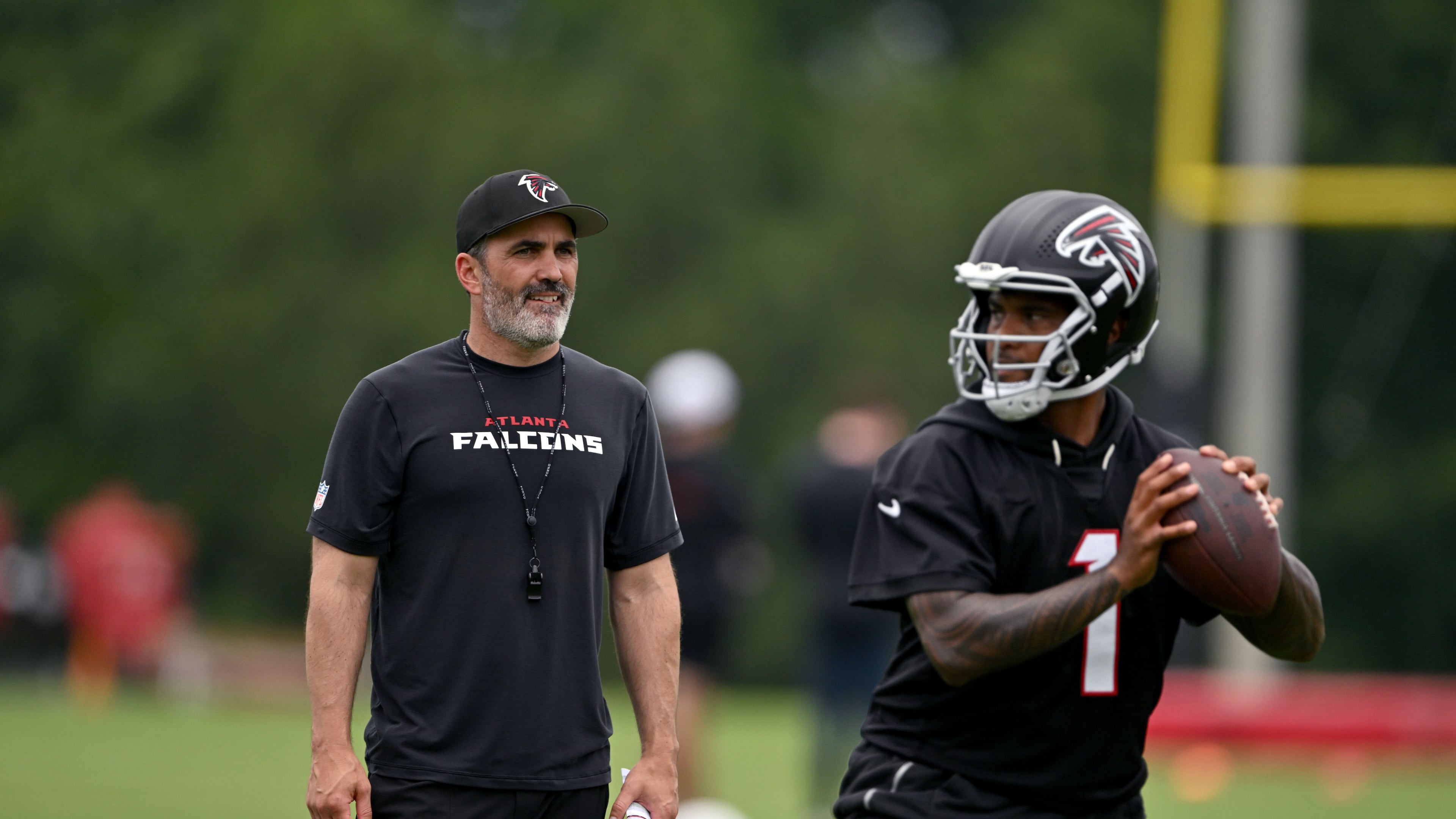 Atlanta Falcons coach Kevin Stefanski watches as Atlanta Falcons quarterback Tua Tagovailoa runs a drill during an OTA workout at Atlanta Falcons Training Facility on Wednesday, May 27, 2026, in Flowery Branch. (Hyosub Shin/AJC)