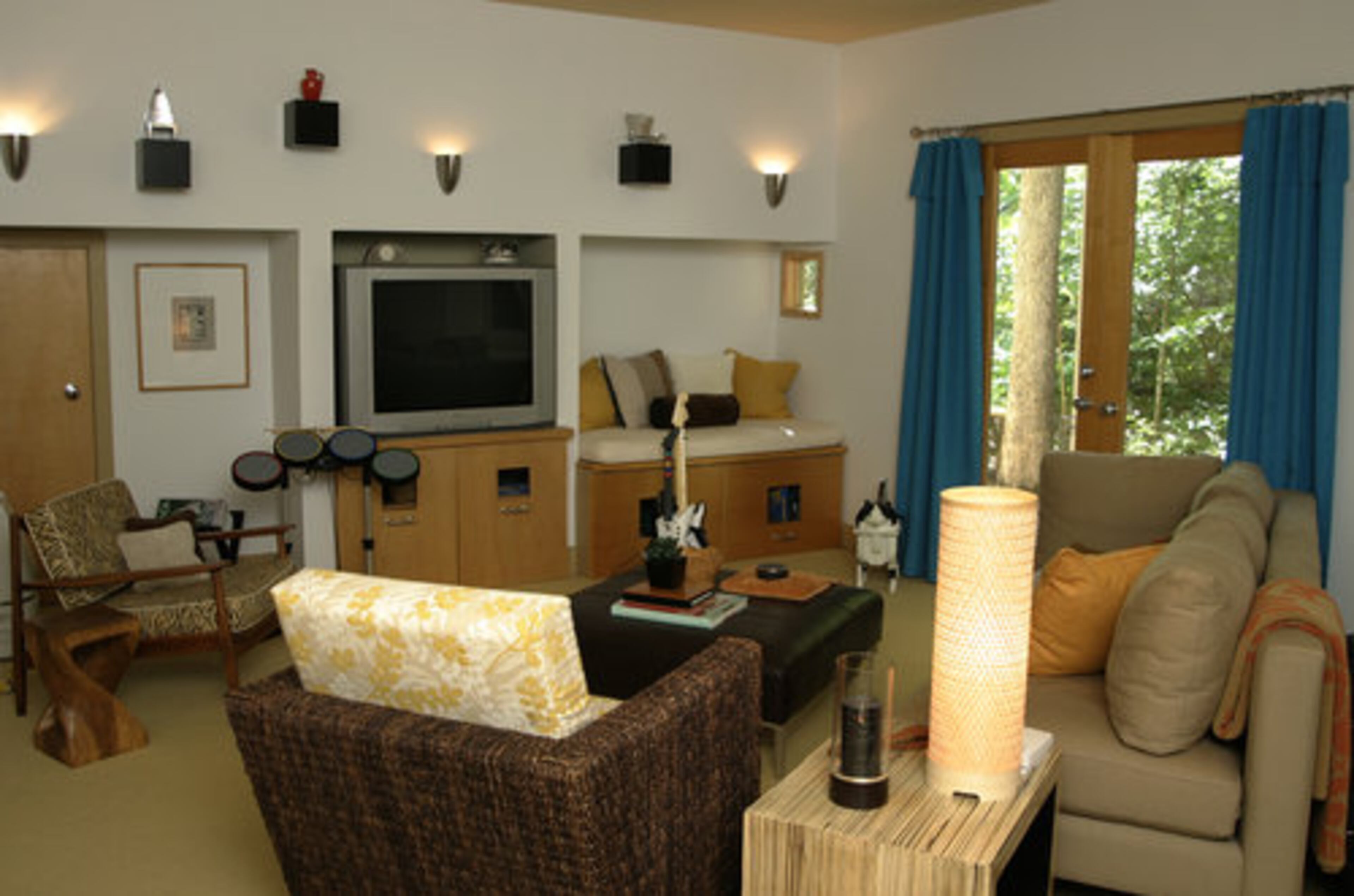 The family enjoys their rec room, which has a prominent music theme. Tyler plays piano and has the guitar and drum set for the video game "Rock Band."