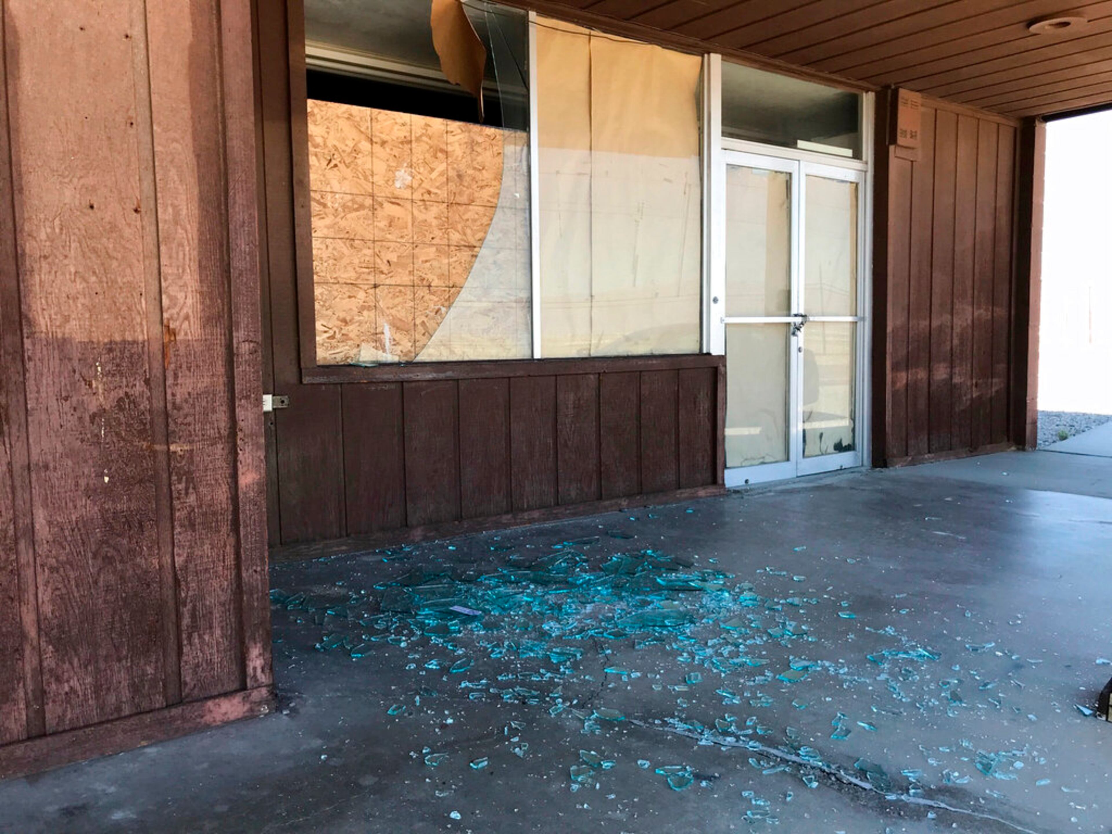 Shattered glass lies on the floor at a vacant business after an earthquake, Thursday, July 4, 2019, in Trona, Calif. A strong earthquake rattled a large swath of Southern California and parts of Nevada on Thursday, rattling nerves on the July 4th holiday and causing some damage in a town near the epicenter, followed by a swarm of aftershocks.