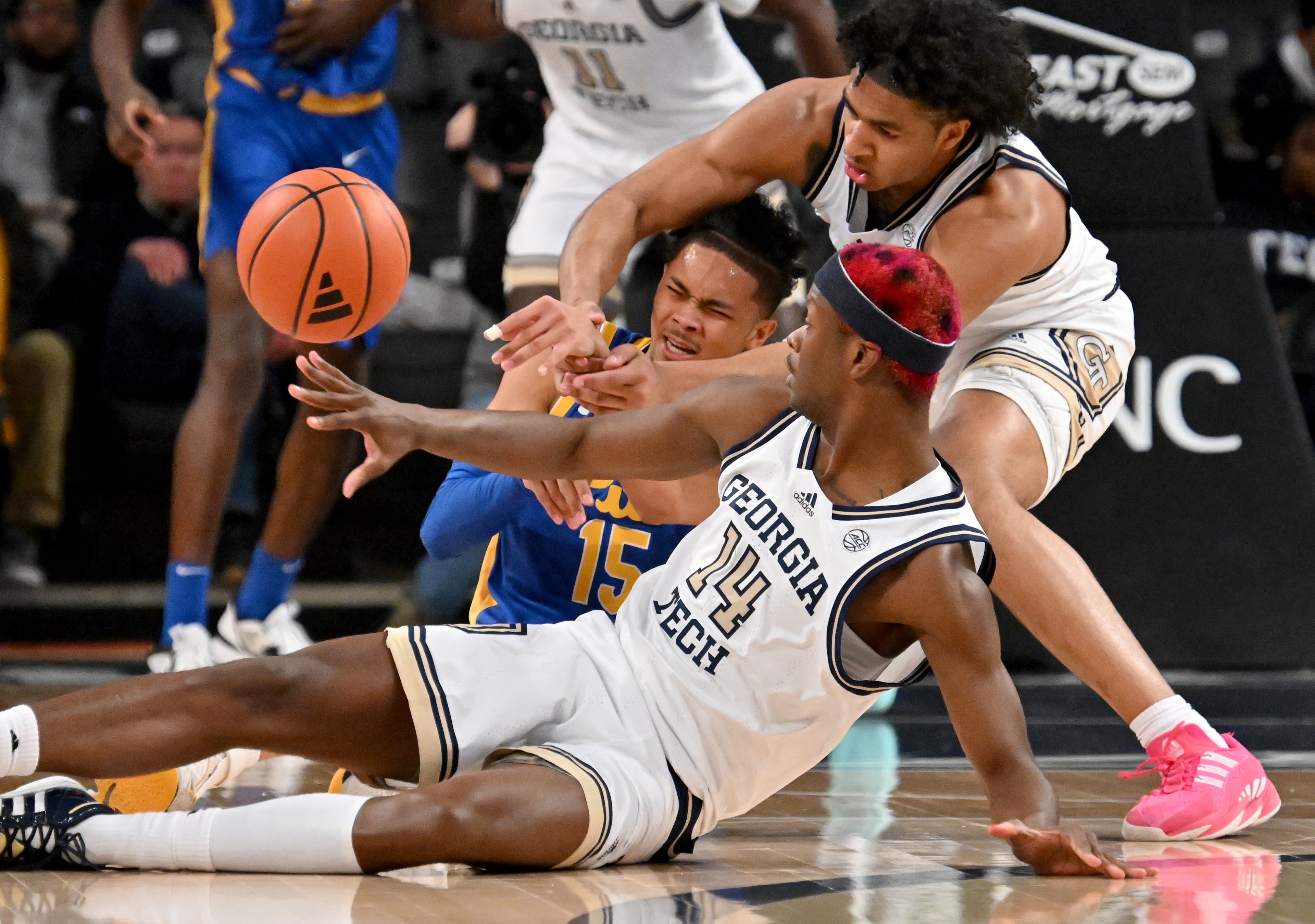 Pittsburgh guard Jaland Lowe (15) fights a loose ball with Georgia Tech guard Kowacie Reeves Jr. (14) and Georgia Tech guard Dallan Coleman (right) during the first half of an NCAA college basketball game at Georgia Tech’s McCamish Pavilion, Tuesday, January 23, 2024, in Atlanta. (Hyosub Shin / Hyosub.Shin@ajc.com)