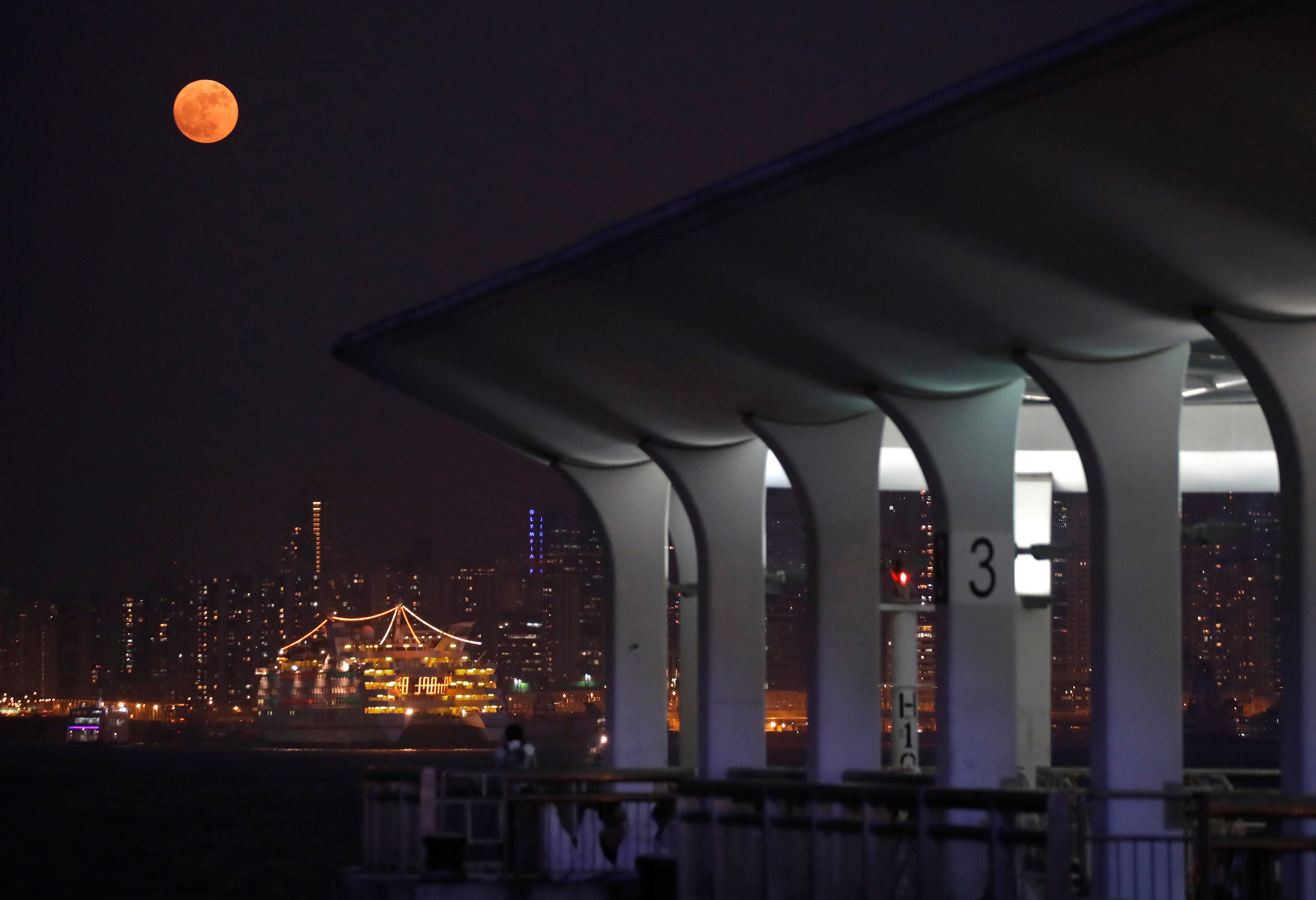 The moon rises over Victoria Habour in Hong Kong, Monday, Nov. 14, 2016. The brightest moon in almost 69 years lights up the sky this week in a treat for star watchers around the globe. The phenomenon is known as the supermoon. (AP Photo/Vincent Yu)