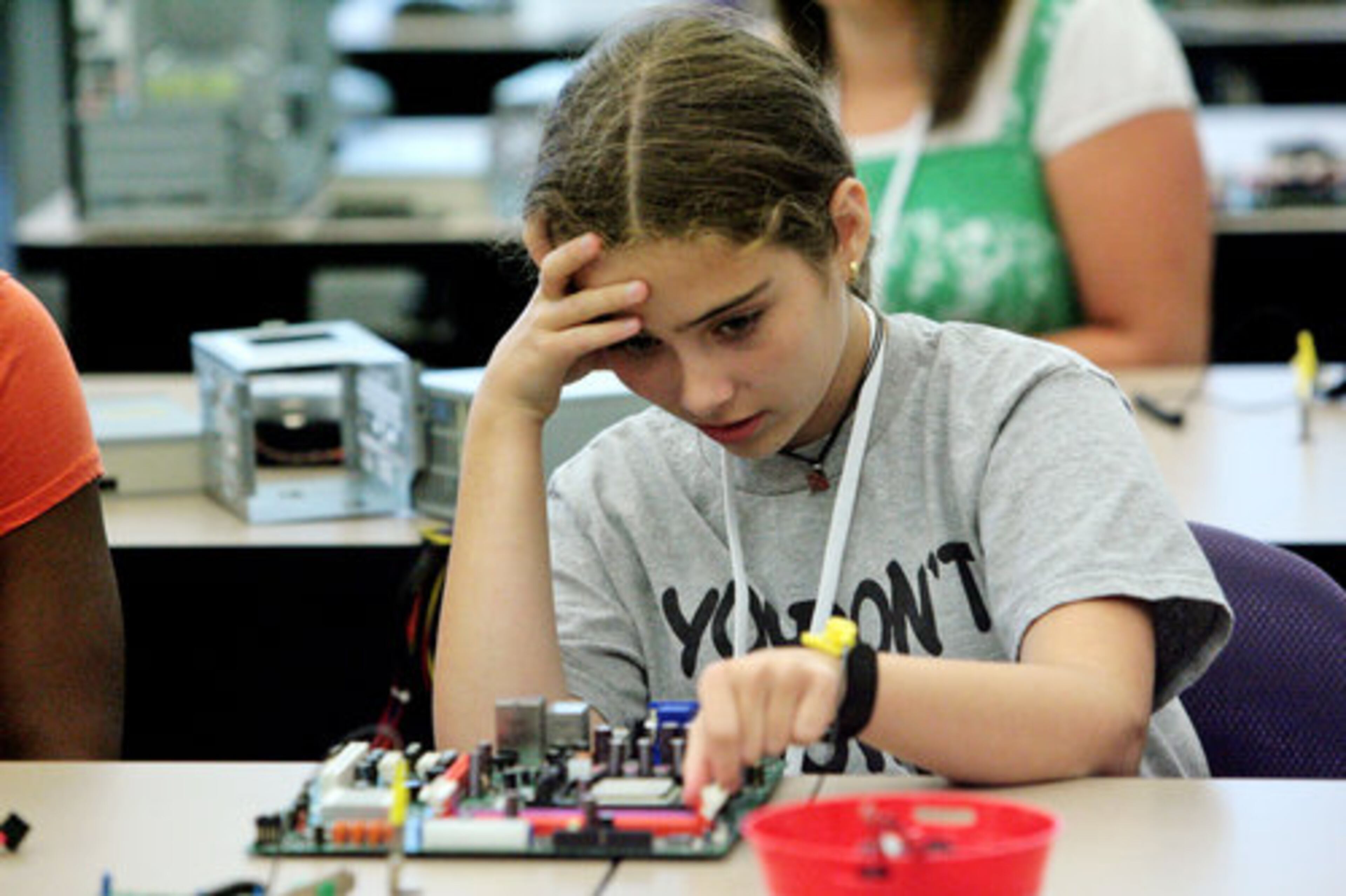 Arianna Sanson, 12, of Stone Mountain, works on a motherboard in the PC-Build class.