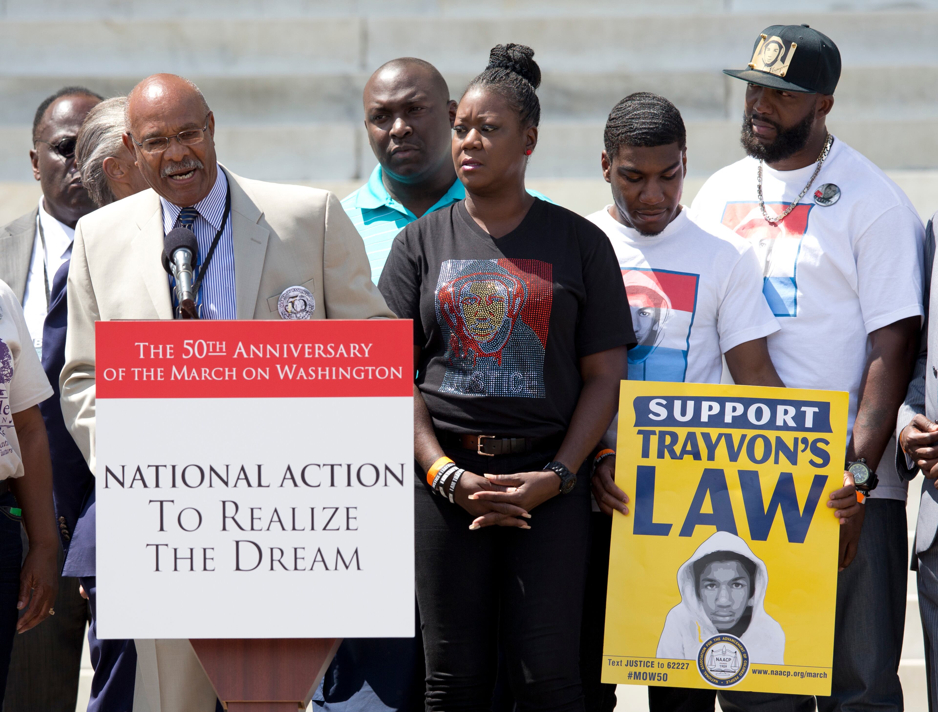 Simeon Wright, Emmett Till's cousin, speaks at the podium in front of the Lincoln Memorial in Washington, Saturday, Aug. 24, 2013, with Sabrina Fulton, mother of slain teenager Trayvon Martin, center, Trayvon's brother Jahvaris Fulton, second from right and Trayvon's father Tracy Martin during the commemoration of the 50th anniversary of the Aug. 28, 1963 March on Washington. (AP Photo/Carolyn Kaster)