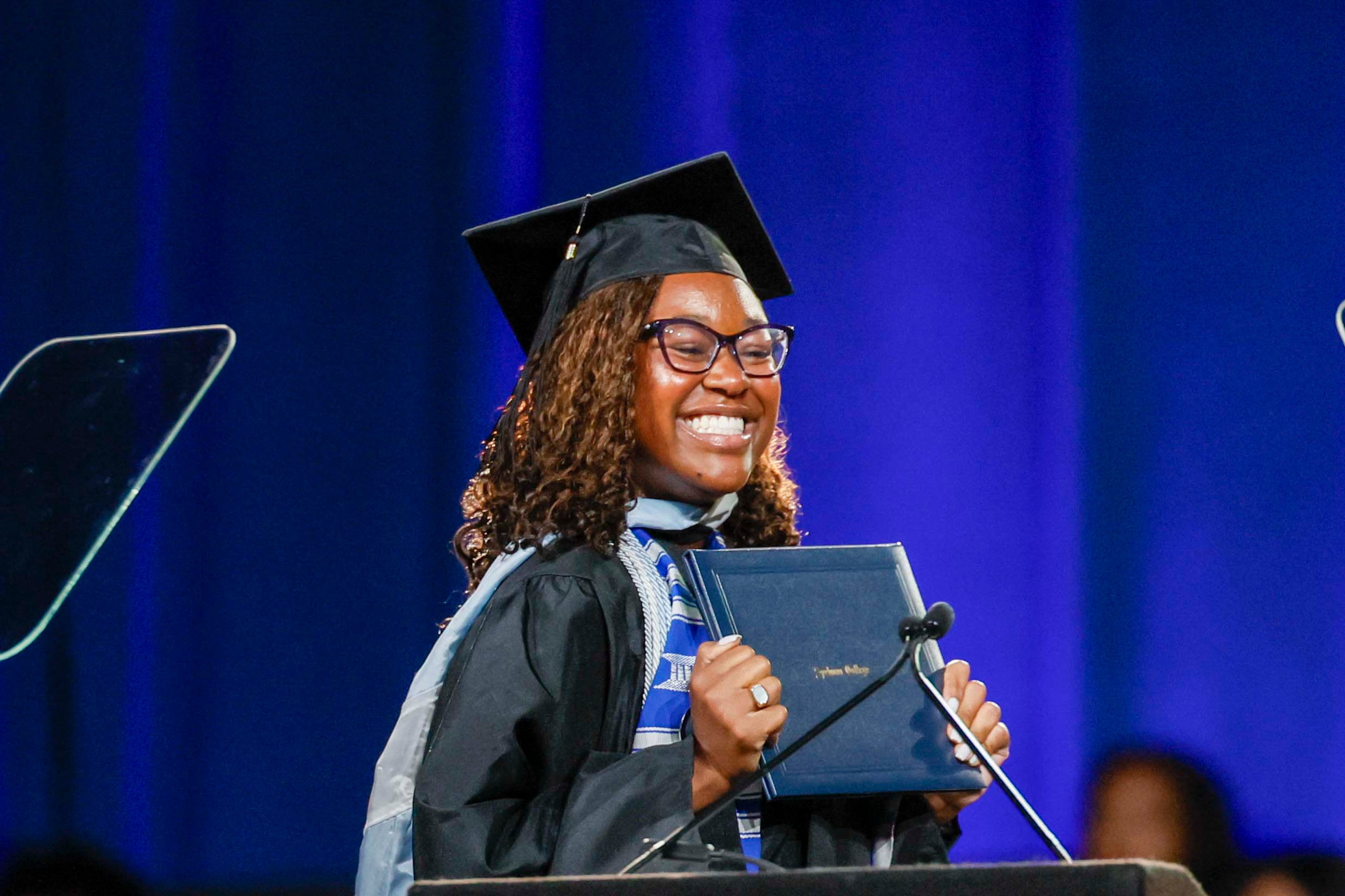 A graduate reacts after receiving her diploma during the Spelman College Commencement at the Georgia International Convention Center in College Park on Sunday, May 17, 2026. (Miguel Martinez/AJC)