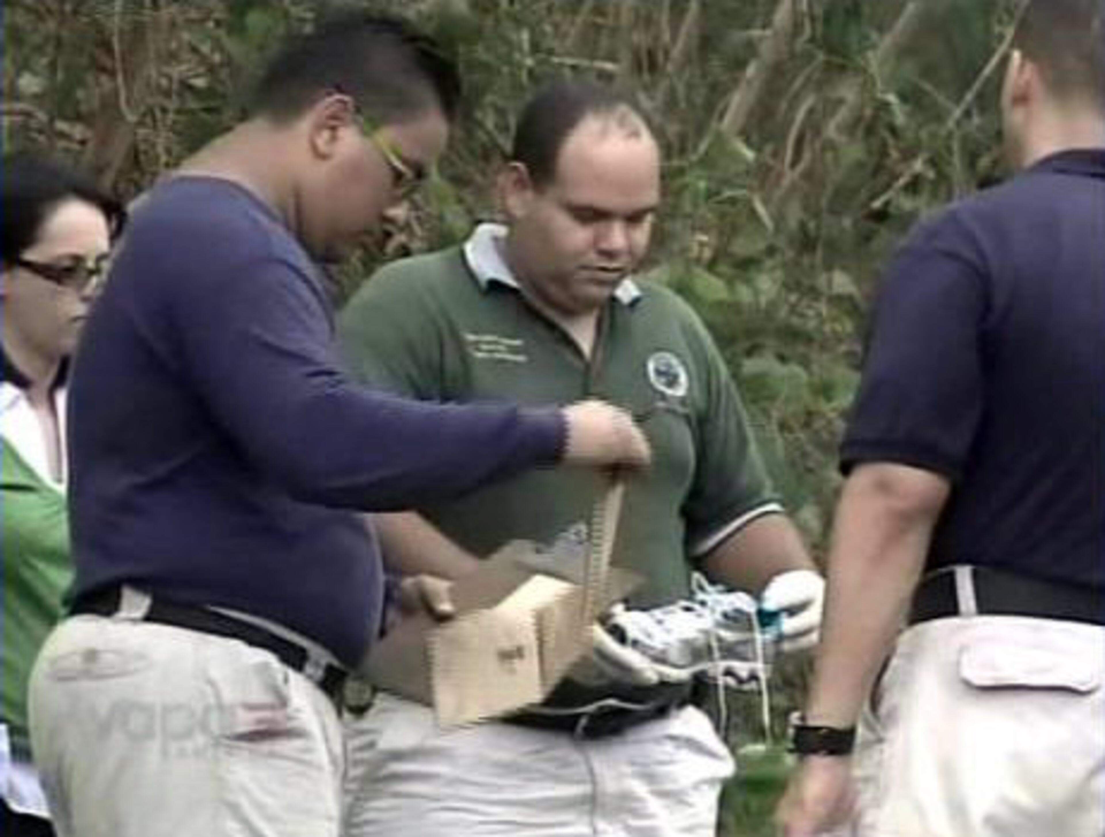A sneaker believed to belong to Kuszak of is removed from the crime scene.