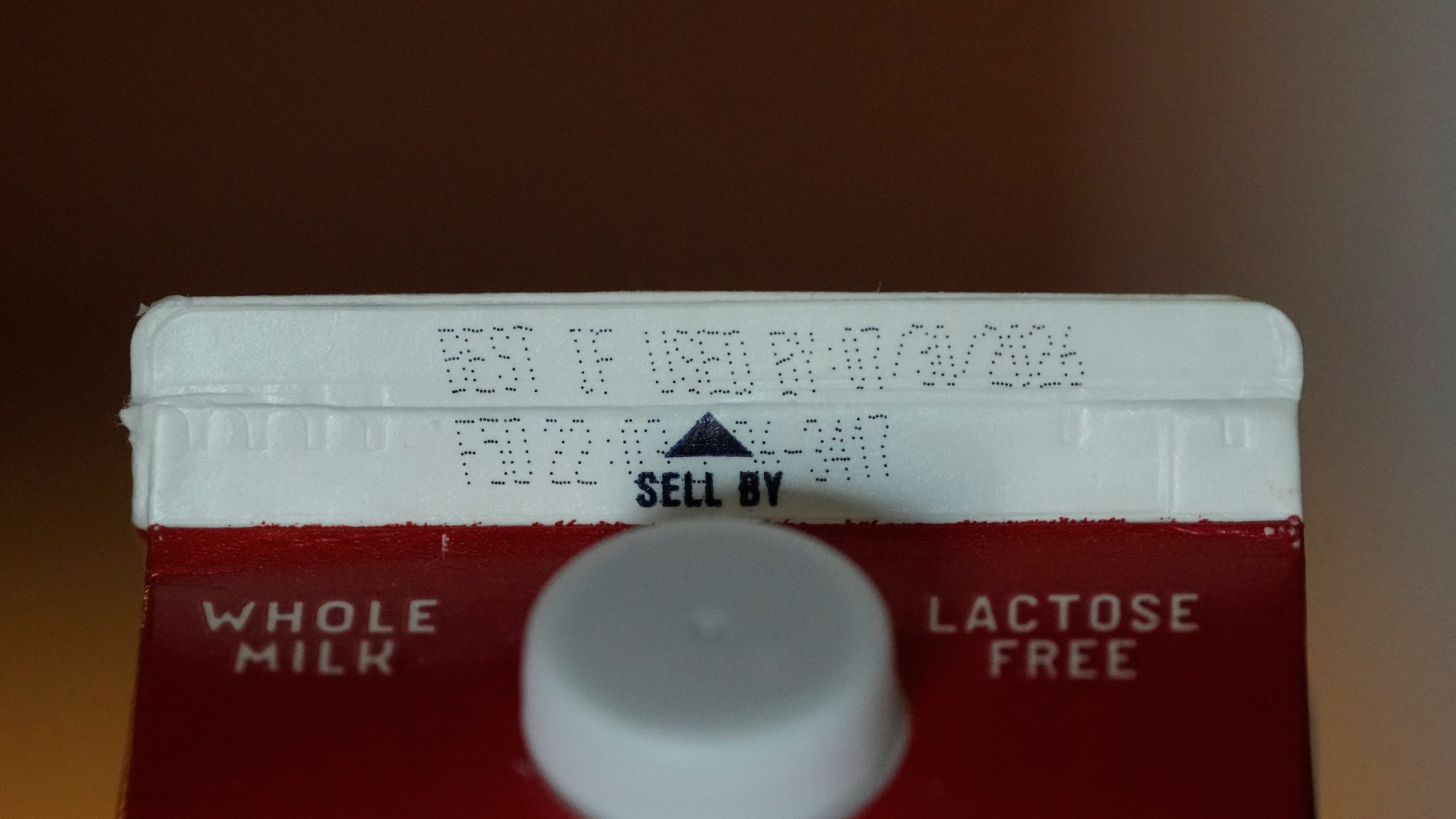 A Best If Used By date is stamped above a Sell By label on a milk carton, Tuesday, June 30, 2026, in San Francisco. (AP Photo/Jeff Chiu)