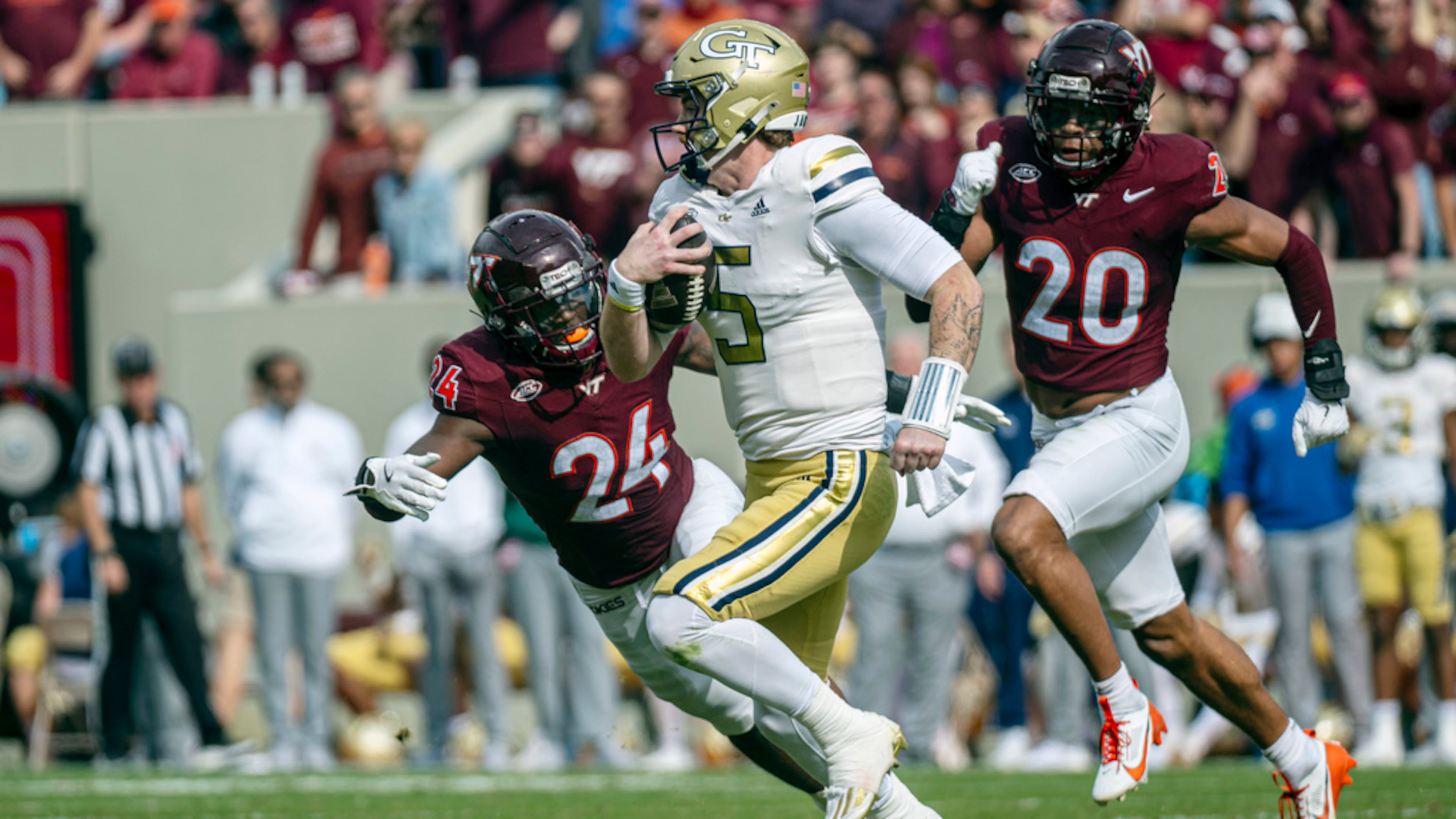 Georgia Tech's Zach Pyron runs the ball against Virgina Tech's Jaden Keller (24) during the second half of an NCAA college football game, Saturday, Oct. 26, 2024, in Blacksburg, Va. (AP Photo/Robert Simmons)